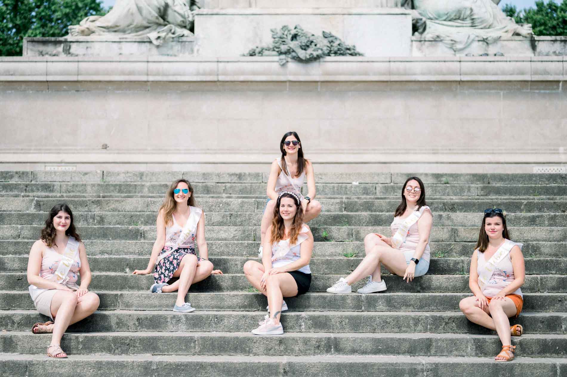 Friends sitting on the steps of the Girondins monument during the hen party