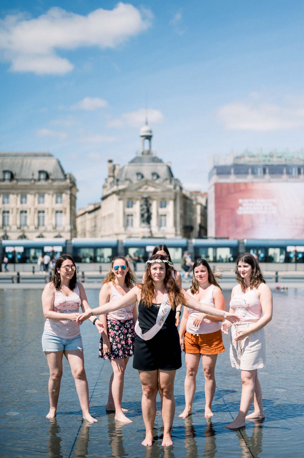 The bride-to-be and her friends paddling in the Bordeaux water mirror