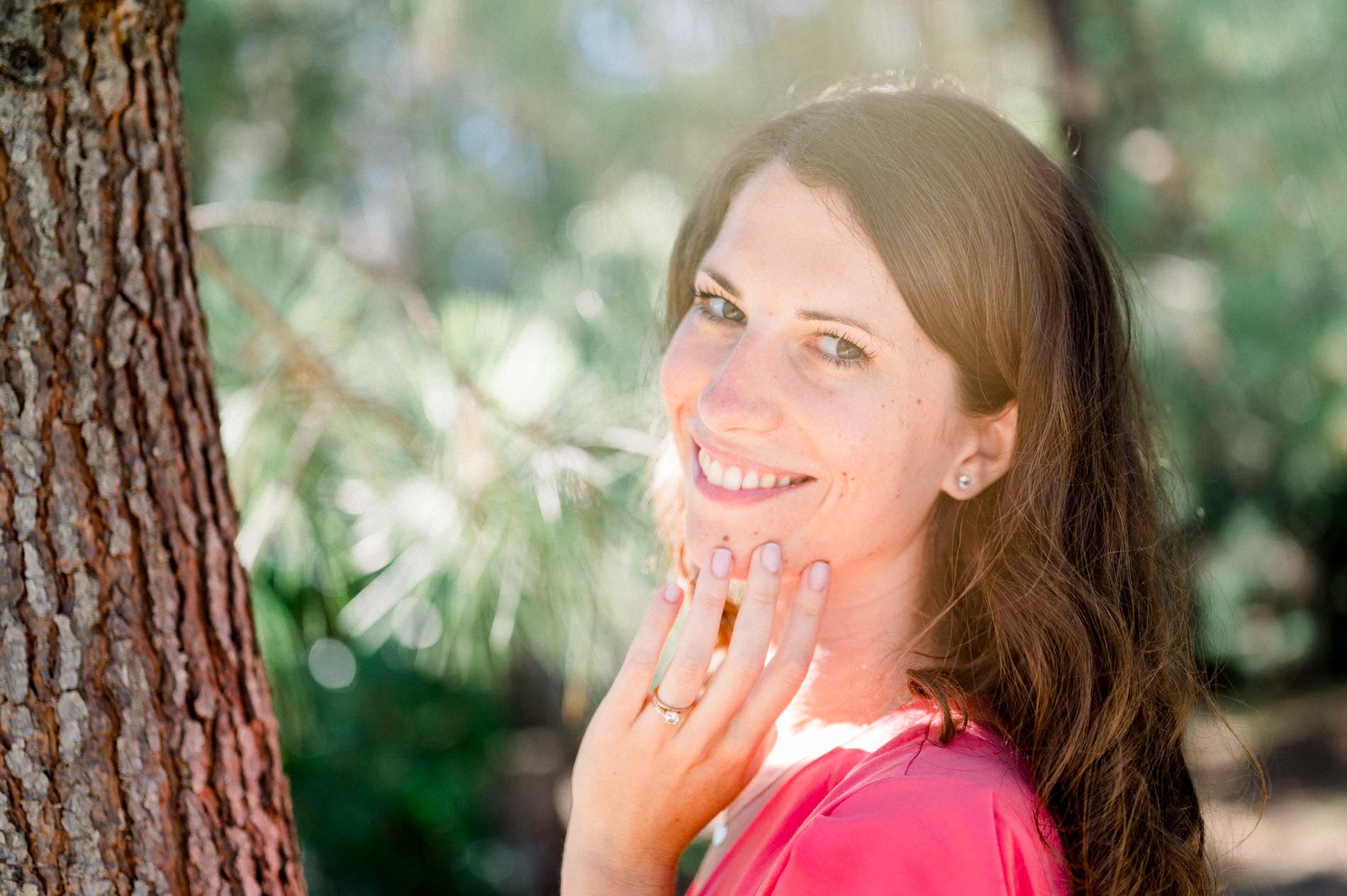 Portrait of the bride-to-be showing her engagement ring, hand to her cheek