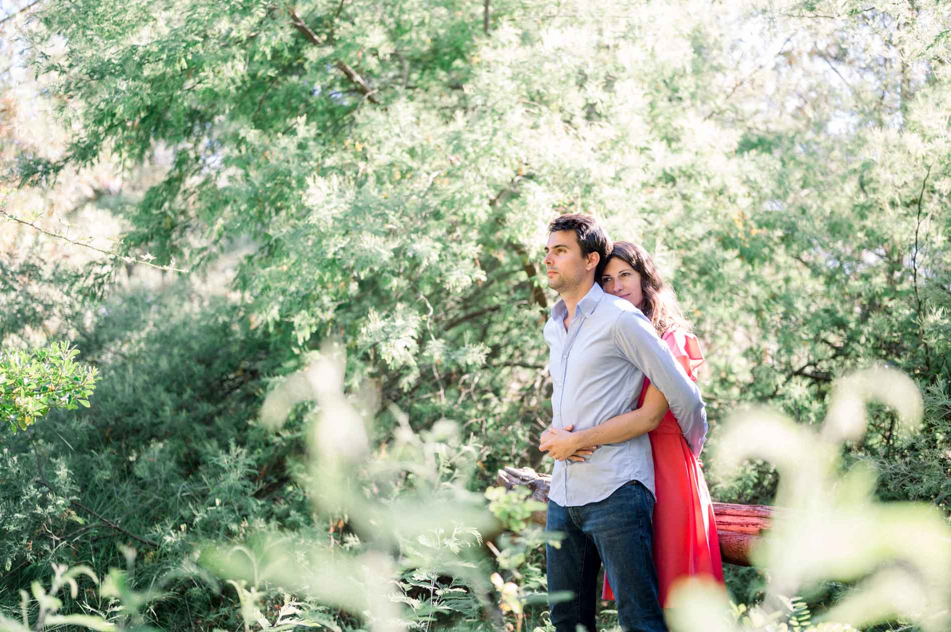 The couple embracing amid the foliage in a forest on Arcachon Bay