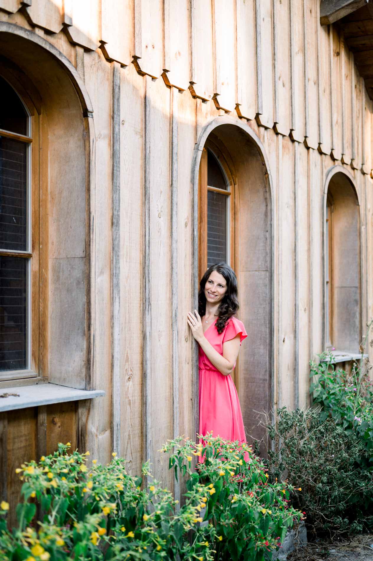 The bride-to-be leaning against the wooden wall of a cabin on Arcachon Bay