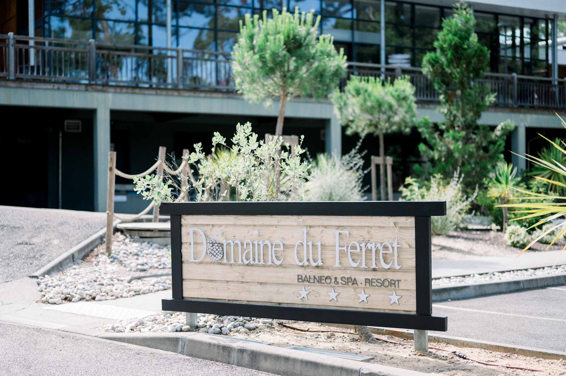 Entrance sign of the Domaine du Ferret in front of the hotel building