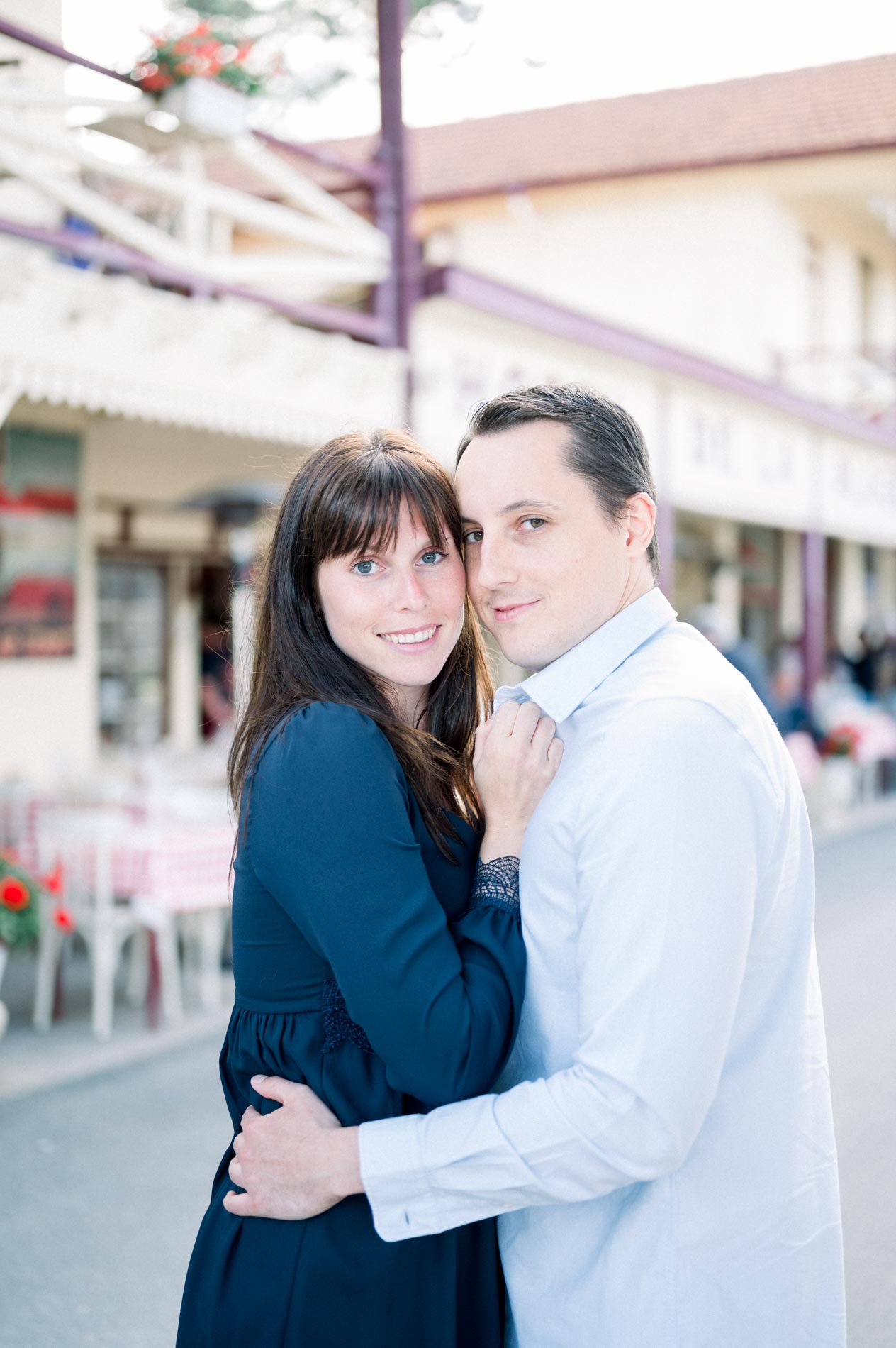 The couple embracing on the main street of the village of L'Herbe, Cap Ferret