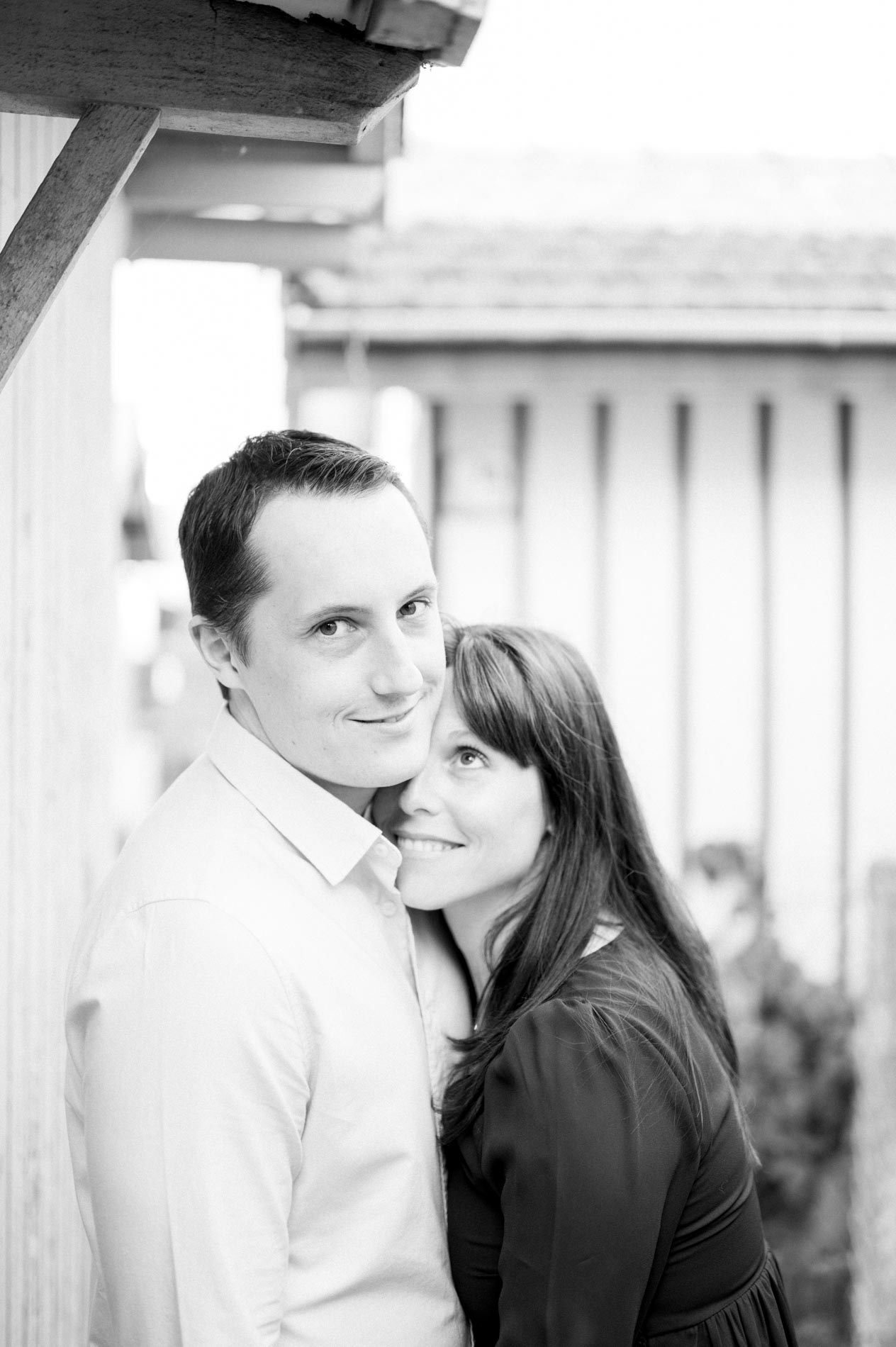 Black and white portrait of the couple close together under an awning