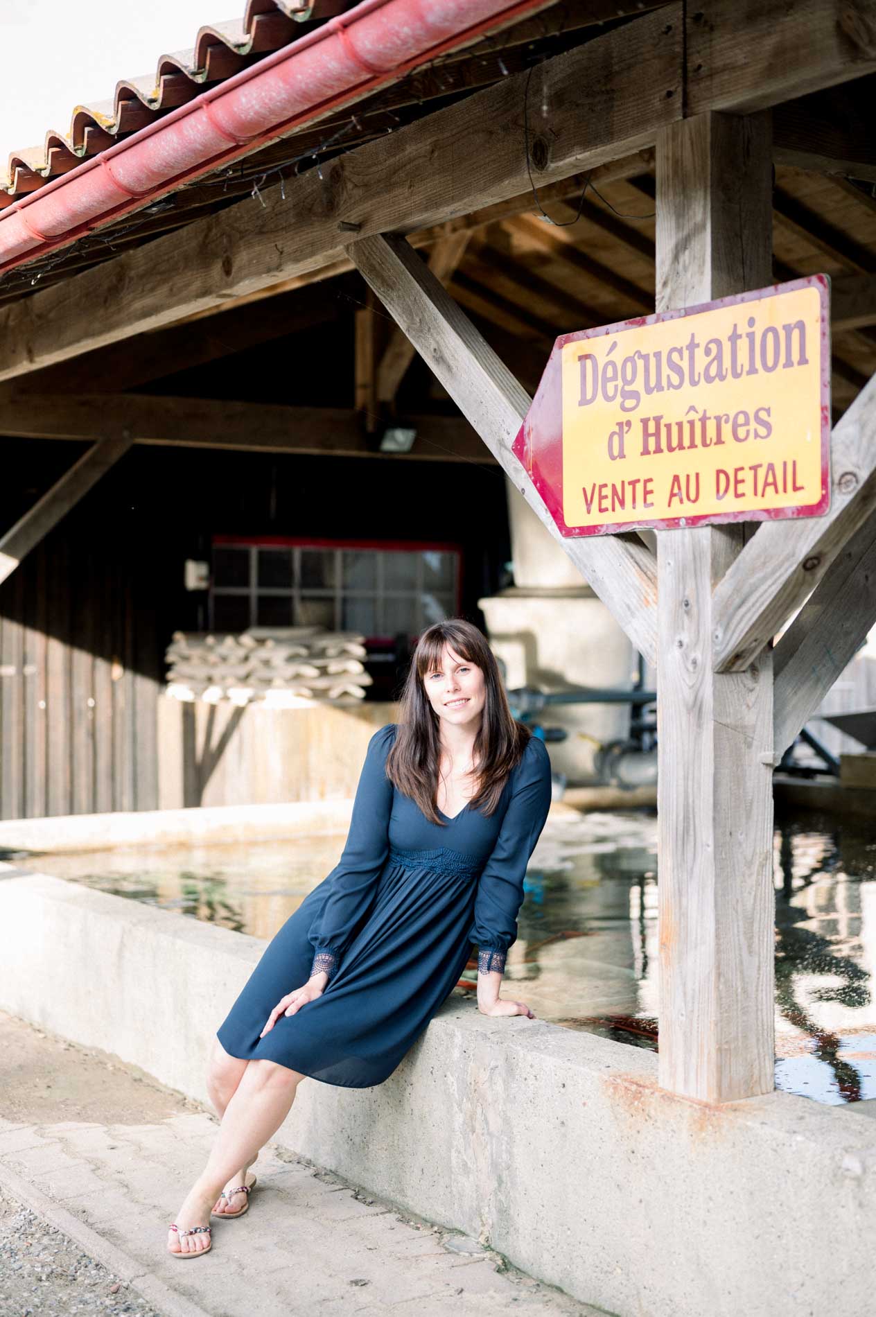 The bride-to-be sitting by an oyster tasting hut