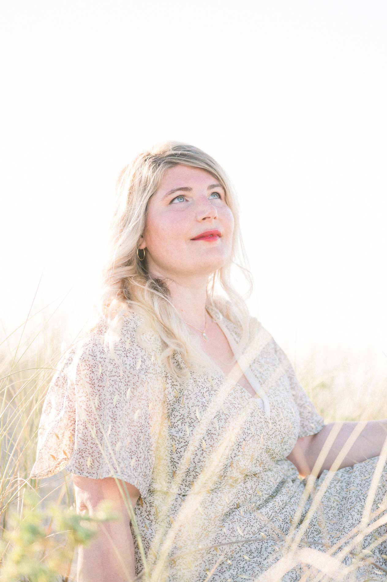 Julie sitting in the dune grass just before the marriage proposal