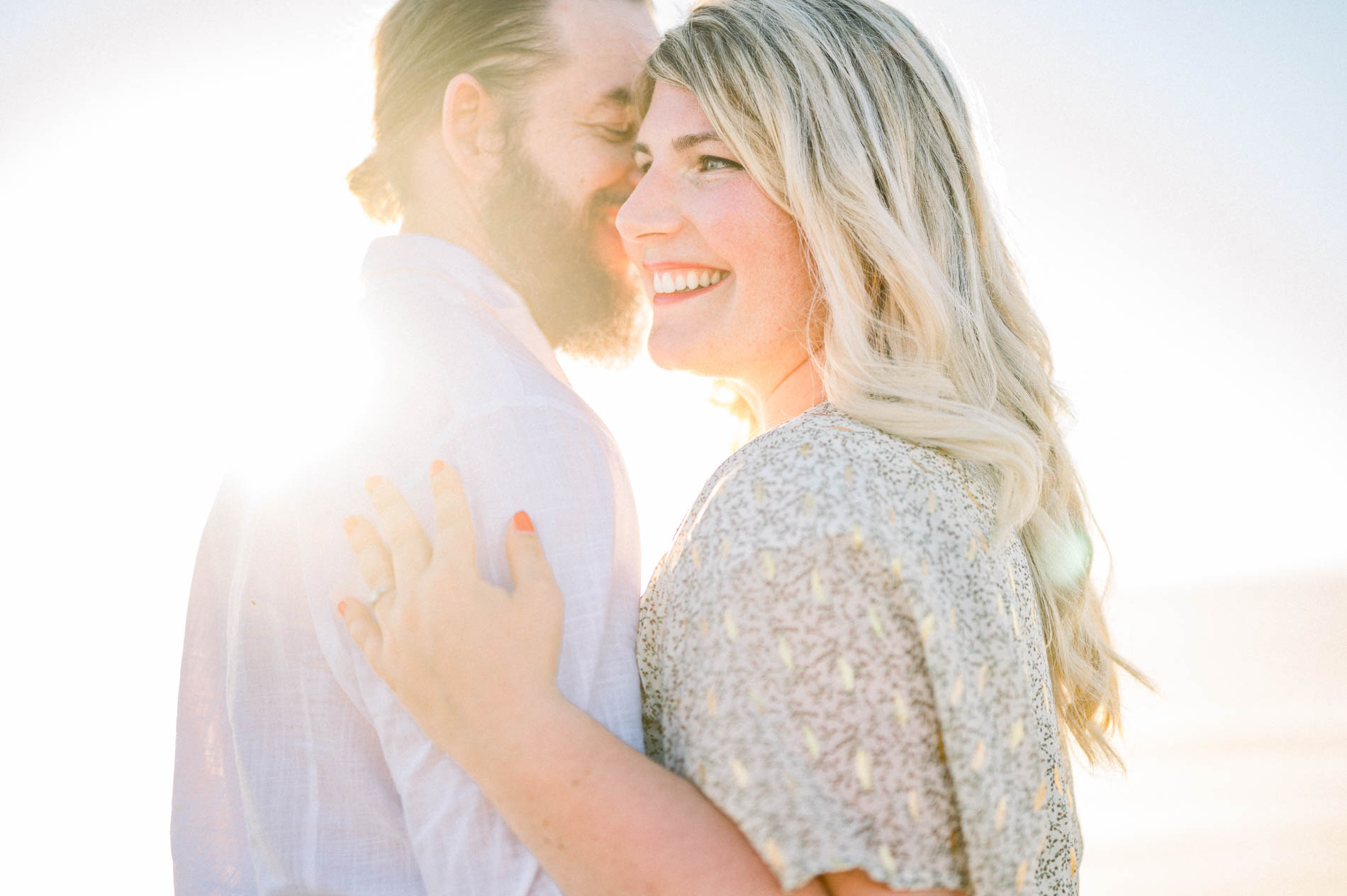 Julie and Derek embracing in the evening light after the proposal