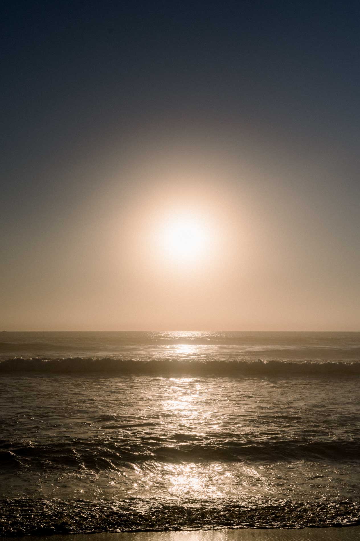 The setting sun reflecting on the ocean waves