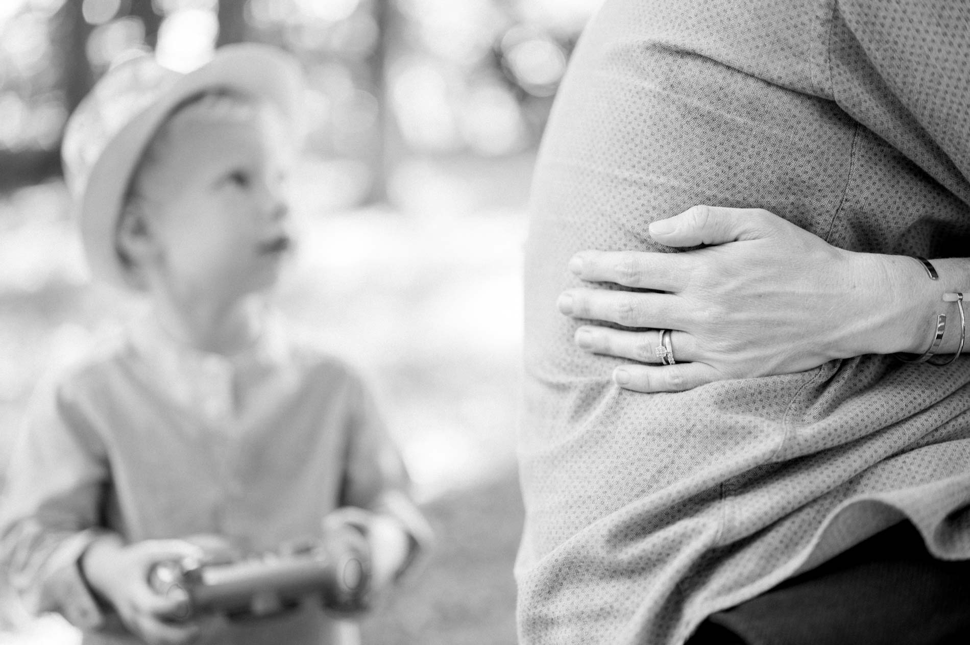 Little boy looking up at his dad, in black and white