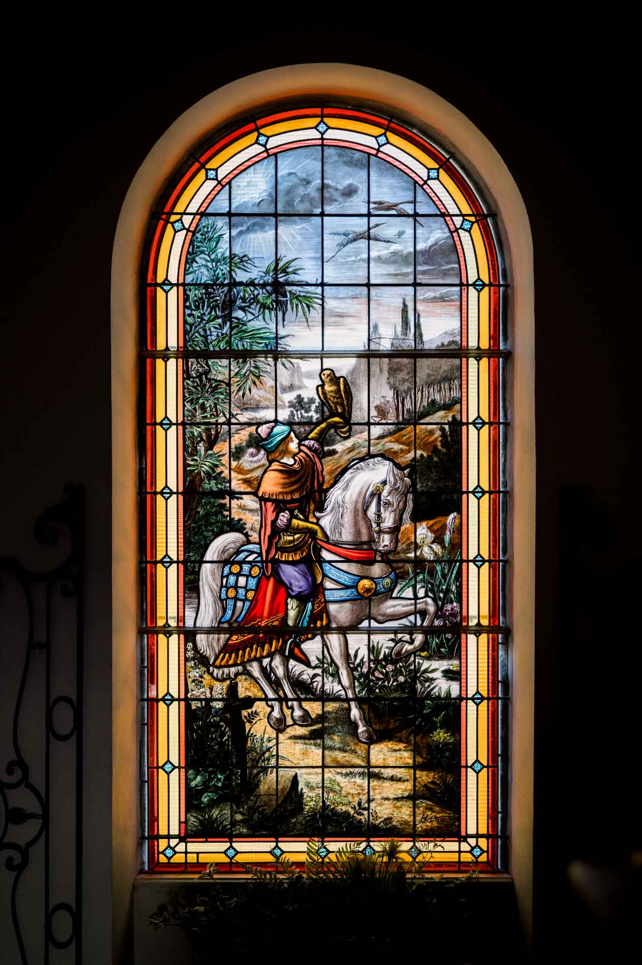 Colourful stained glass window depicting a knight, photographed on the wedding day