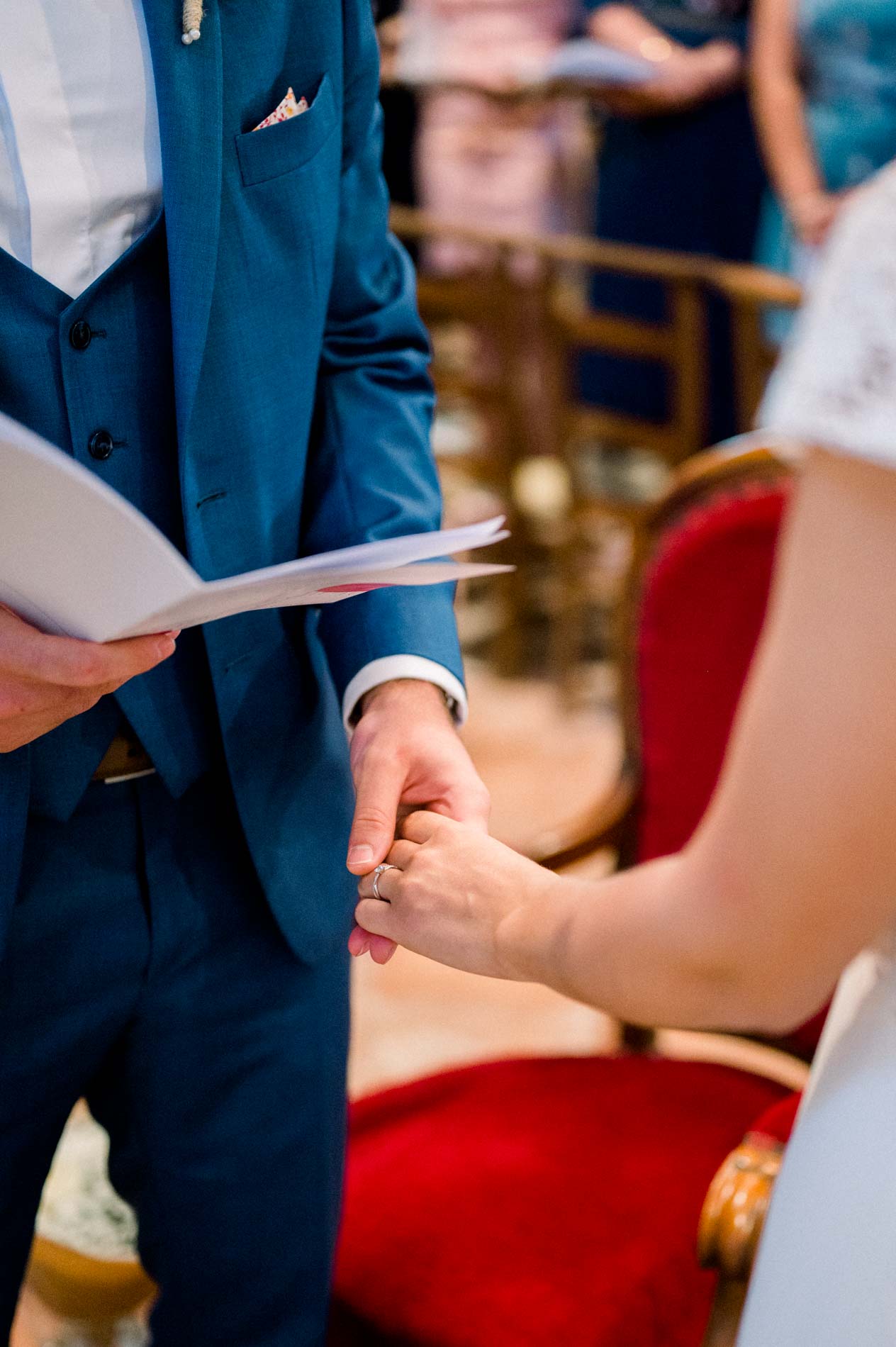 Bride and groom holding hands during the church wedding service