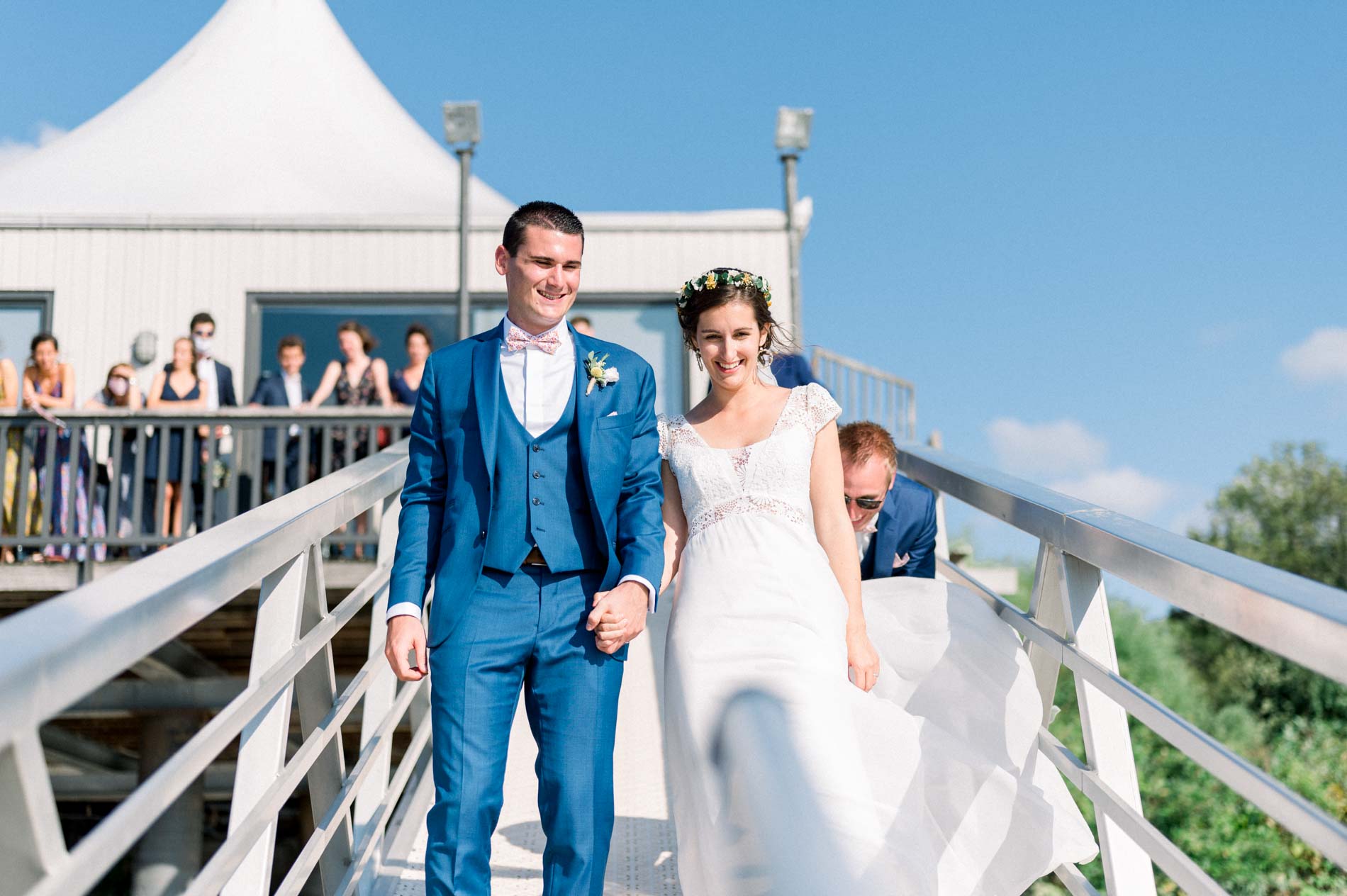 The bride and groom walking down the gangway to the boat on the Garonne