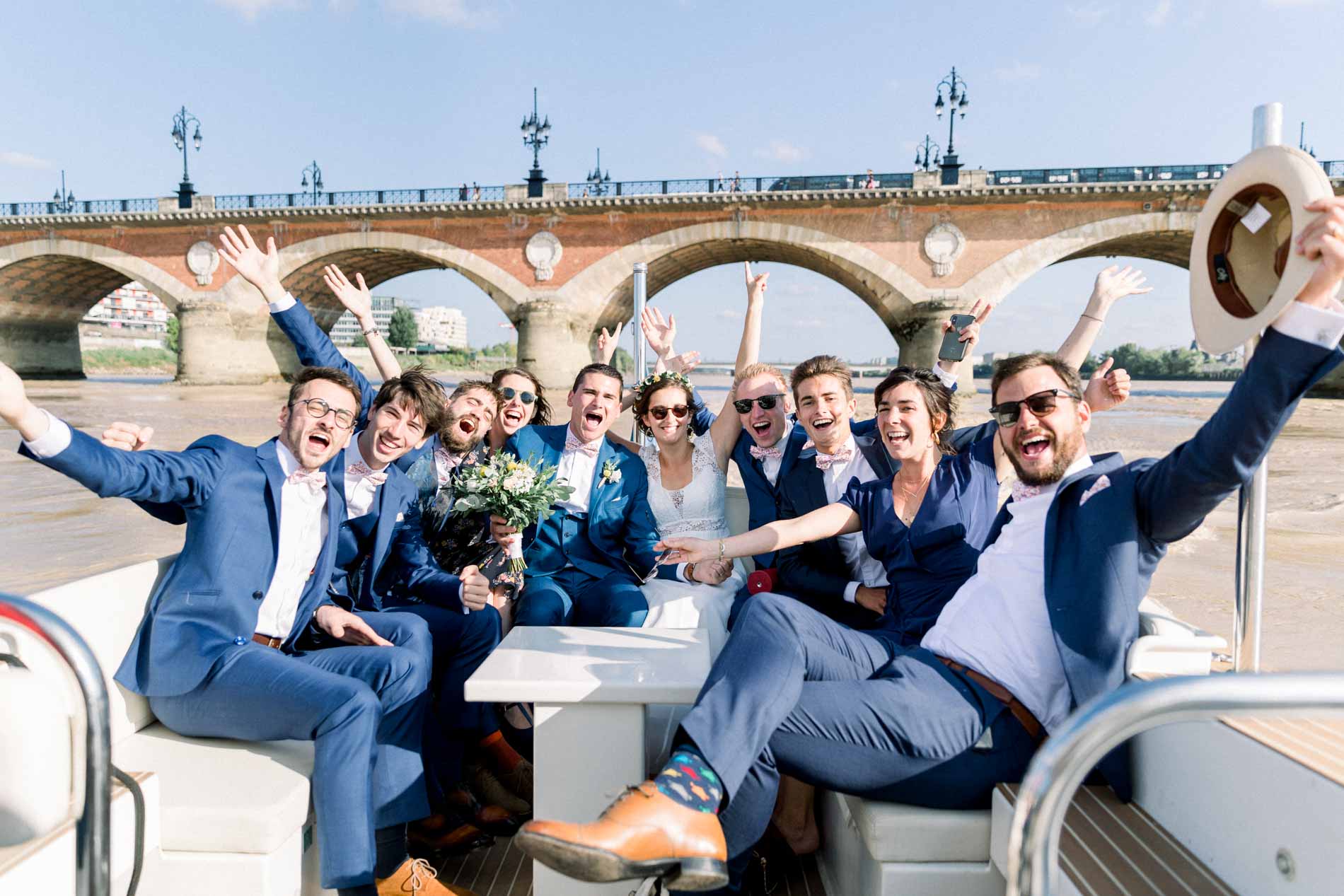 Guests cheering on the boat in front of the Pont de Pierre in Bordeaux