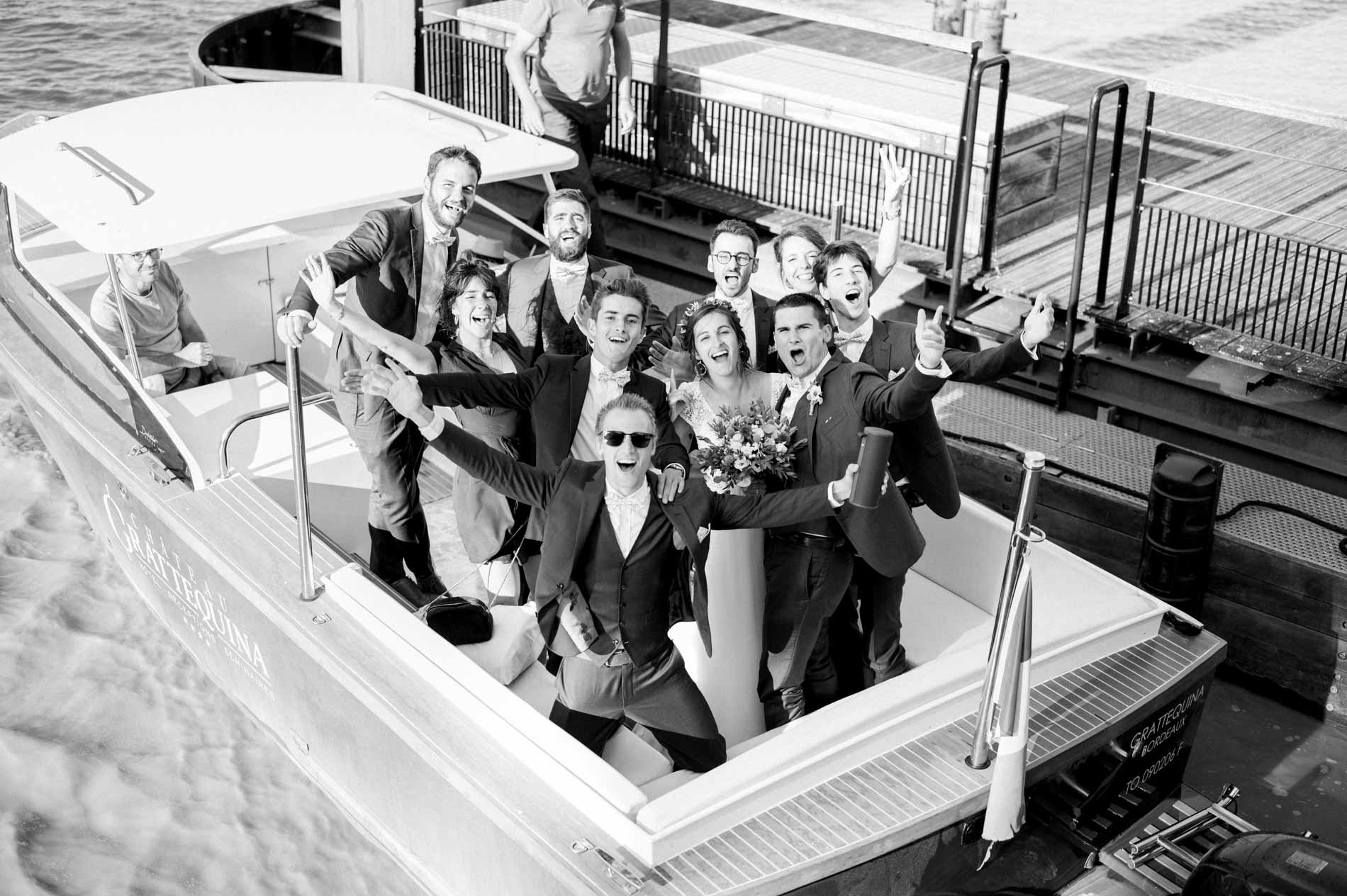 Couple and guests on board the boat arriving at the château, in black and white