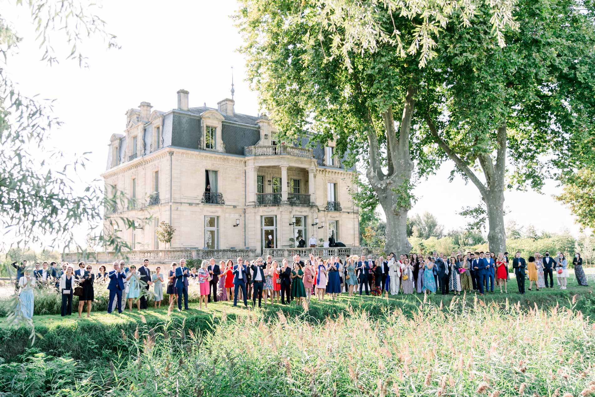 Guests gathered on the lawn in front of Château Grattequina