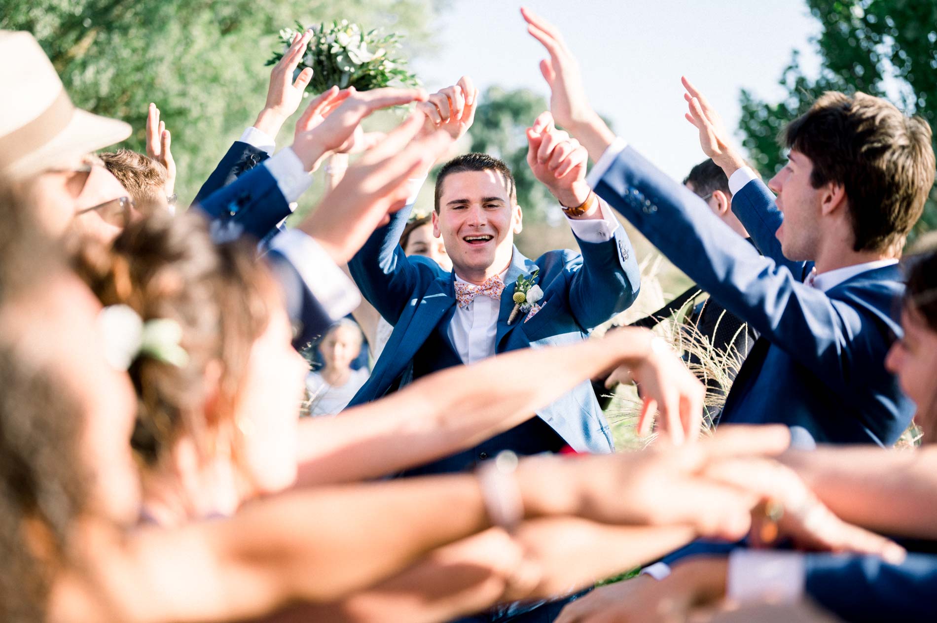 Guests welcoming the couple with raised arms and cheers