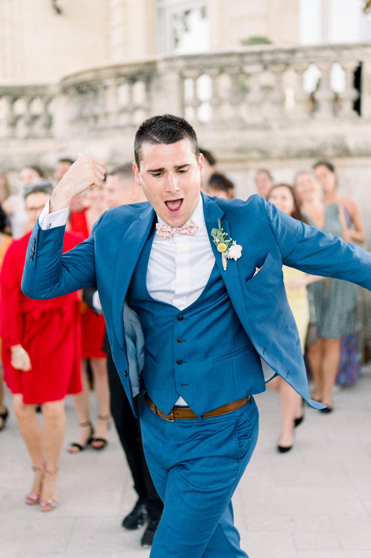 Groom dancing during the flash mob in front of the guests