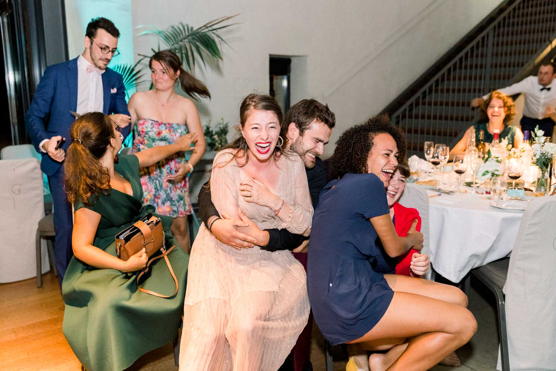 Guests in fits of laughter during an evening wedding game
