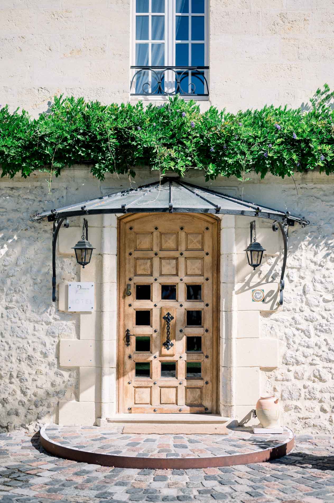 Wooden front door of Domaine de Larchey, where the wedding preparations took place