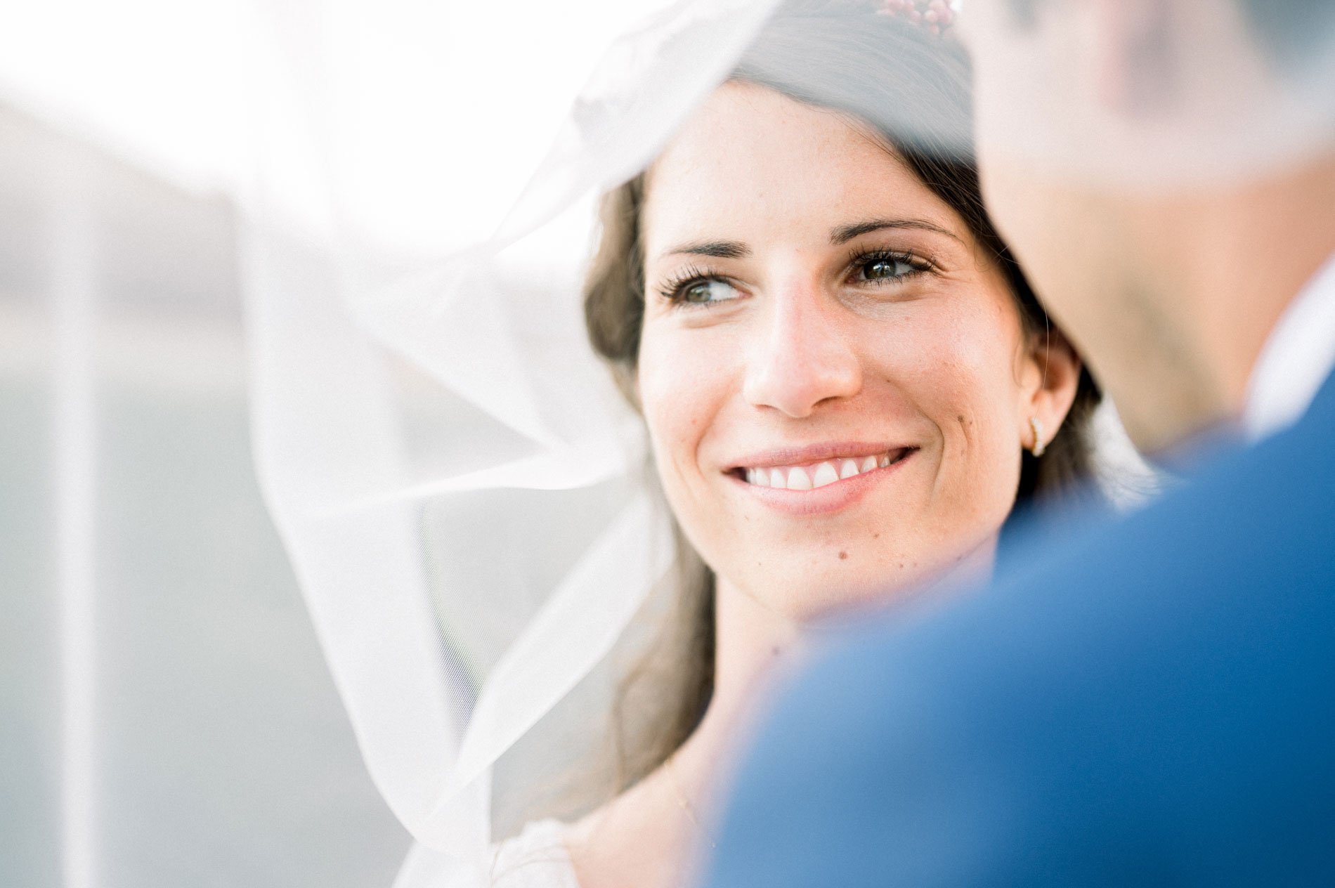Sonia smiling beneath her veil, facing Aurélien