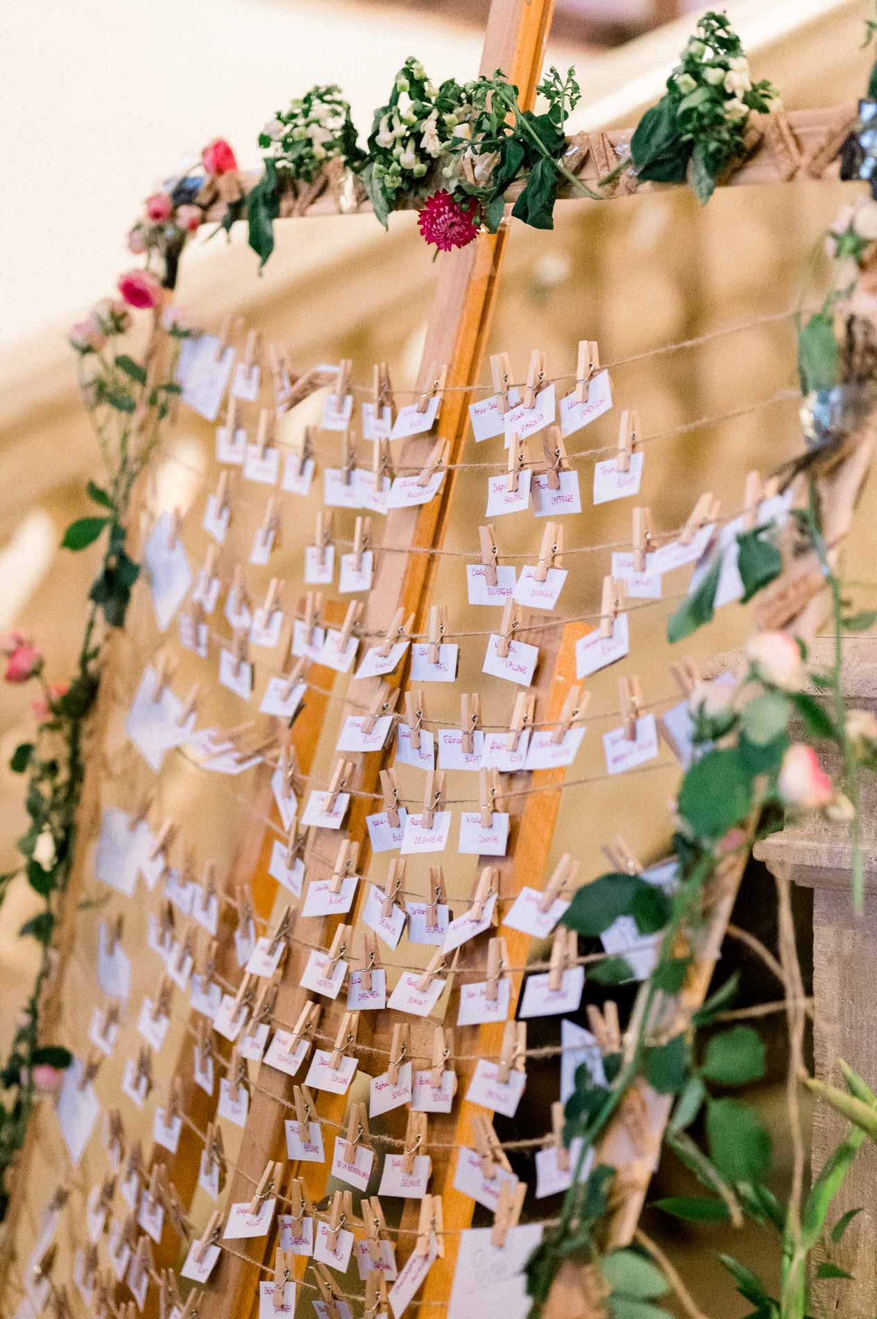 Close-up of the seating chart with hanging name cards and roses