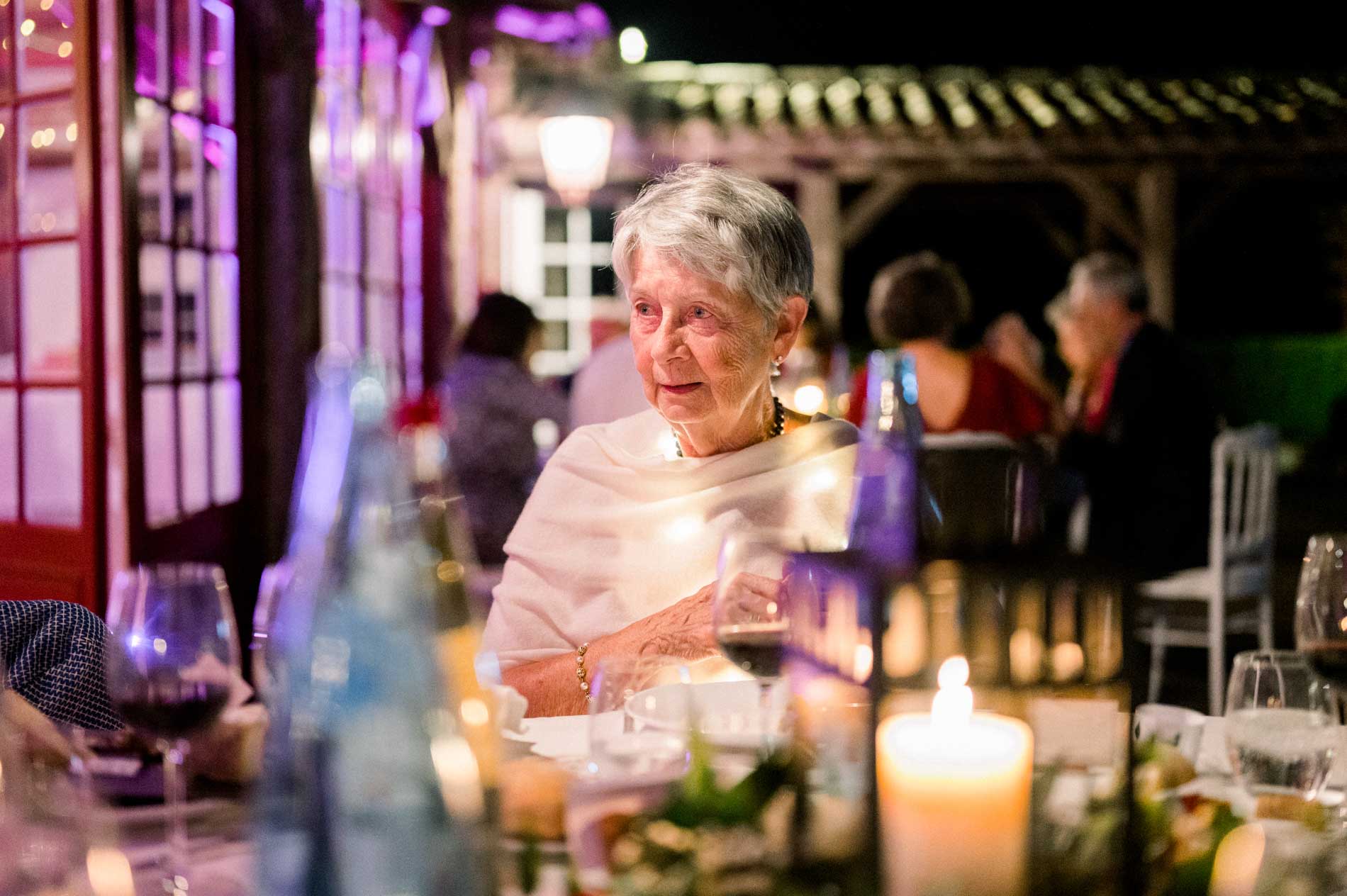 Guest lit by candlelight during the wedding dinner