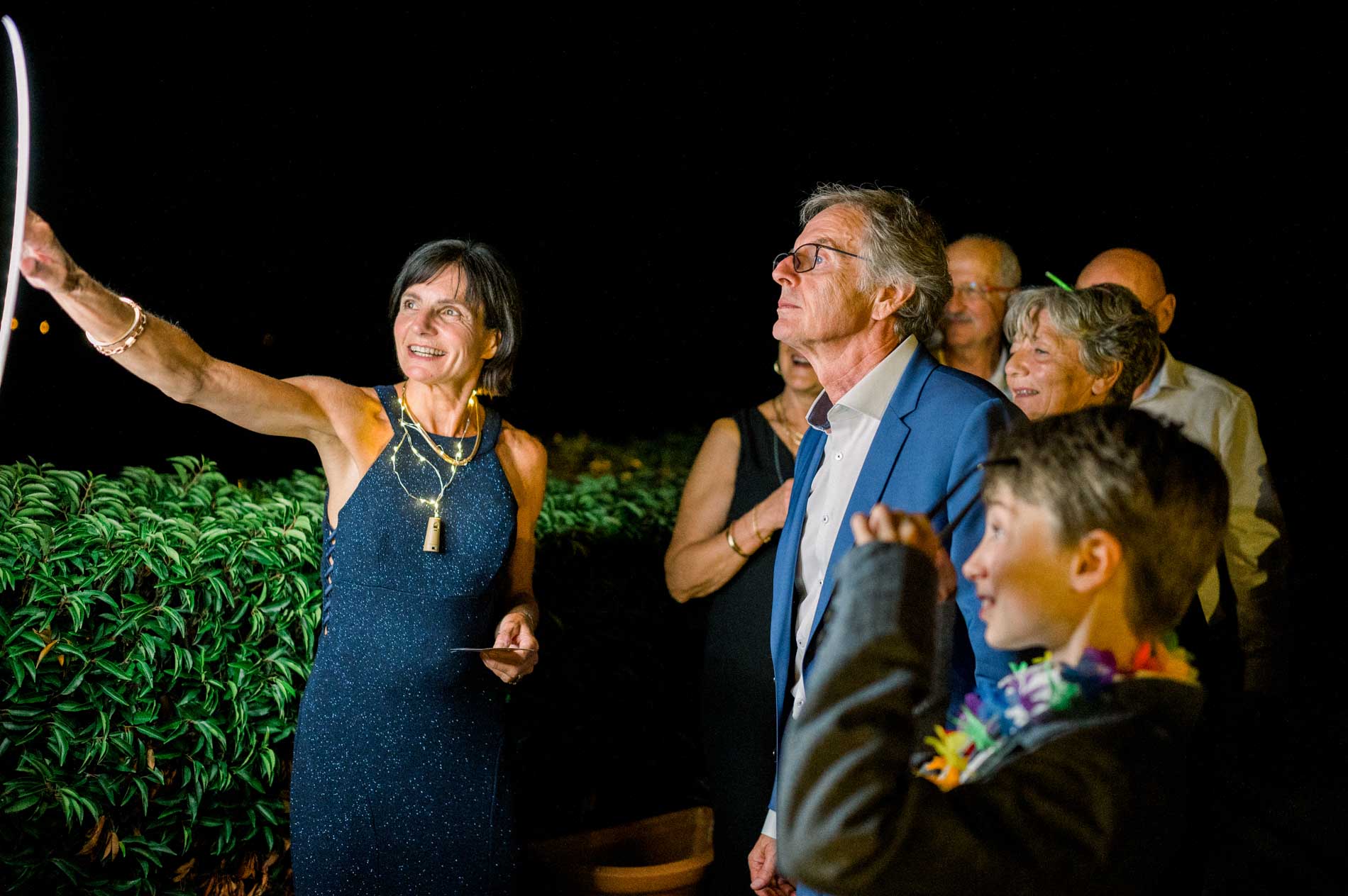 Guests gathered outside after dark during the wedding party