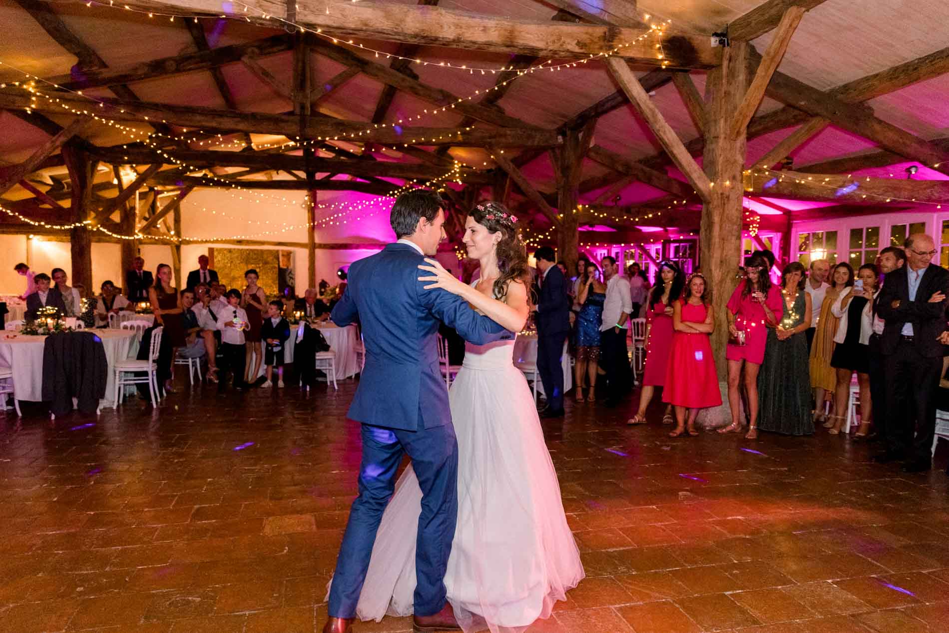 The couple's first dance beneath string lights at Château Smith Haut Lafitte