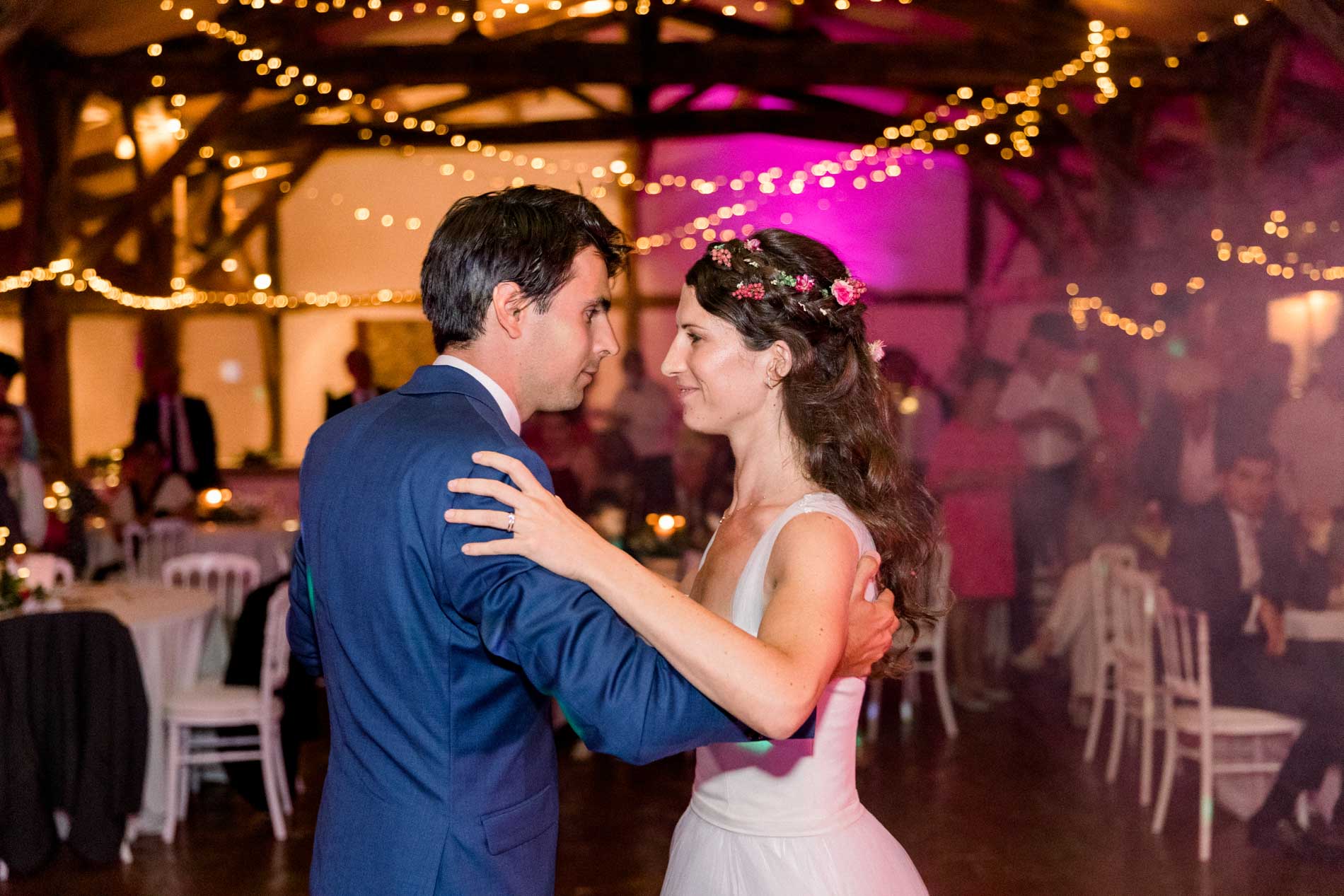 The bride and groom gaze at each other during their first dance