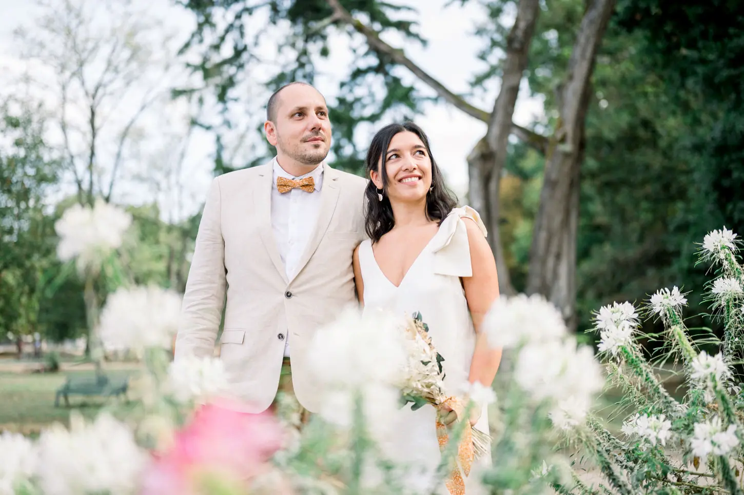 Bride and groom among white flowers in Parc Cazalet in Pessac