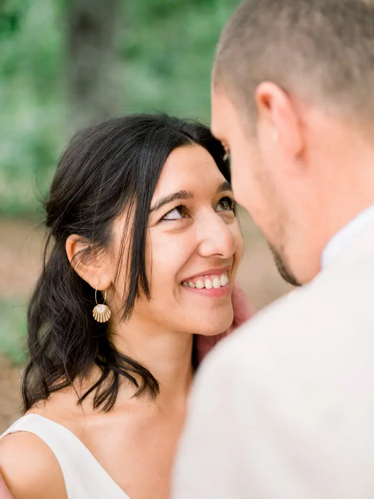 The bride smiling at the groom, foreheads touching, in the Parc de Cazalet