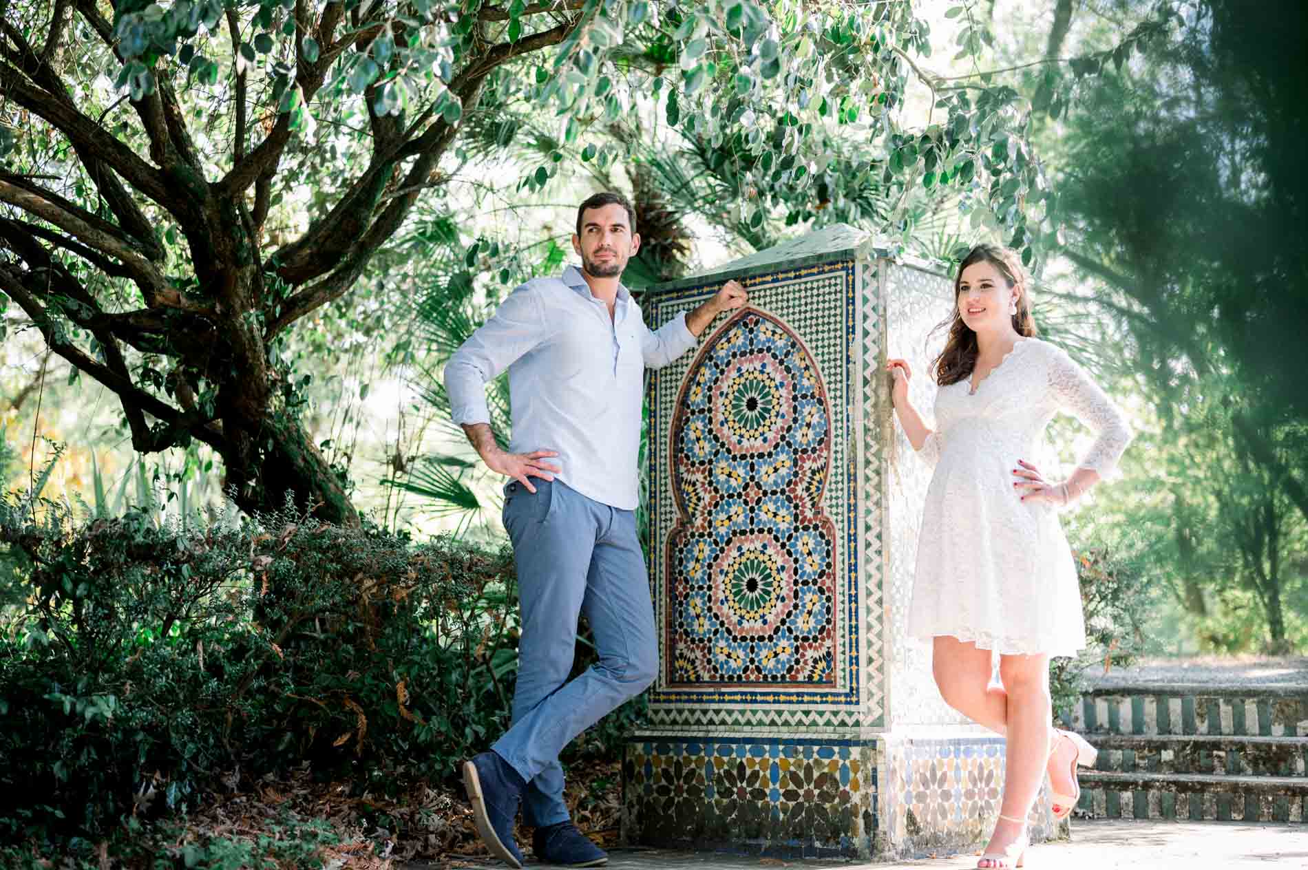 Couple on either side of a zellige fountain in the garden