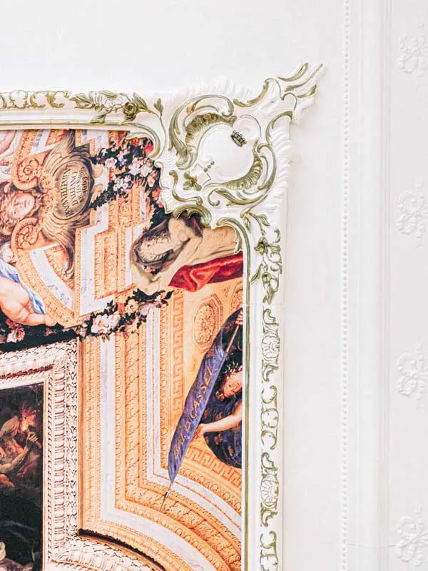 Detail of a painted ceiling and gilded mouldings in a château hallway