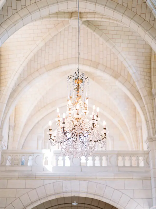 Crystal chandelier hanging beneath the vaults of Notre-Dame de Cabara church