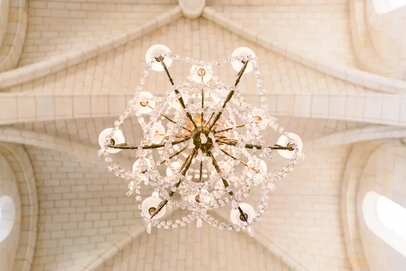 Crystal chandelier seen from below under the vaulted ceiling of Cabara church