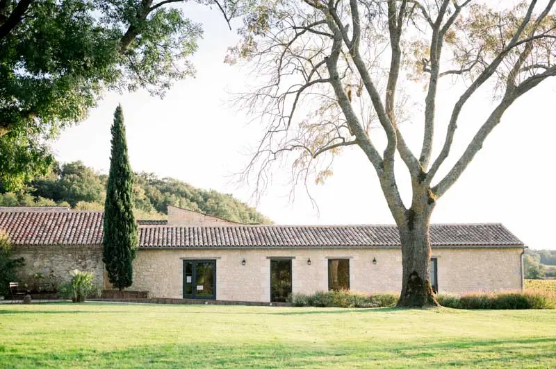 Stone reception building and large tree on the estate lawn