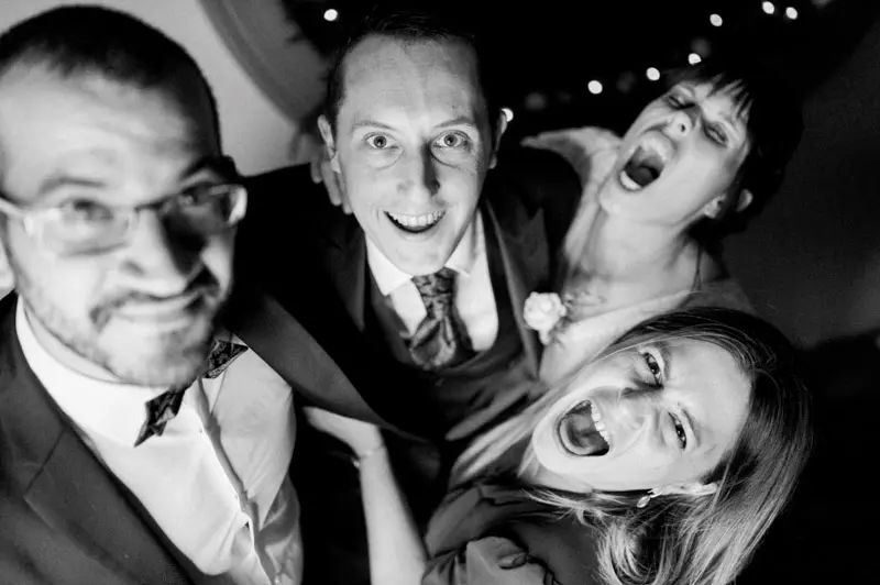 Guests pulling faces in a party selfie, in black and white