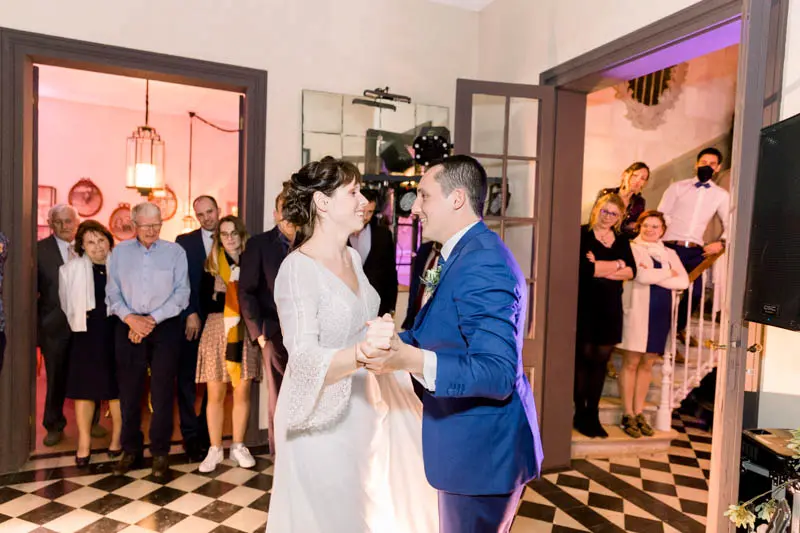 Bride and groom's first dance surrounded by guests at Château de Garde