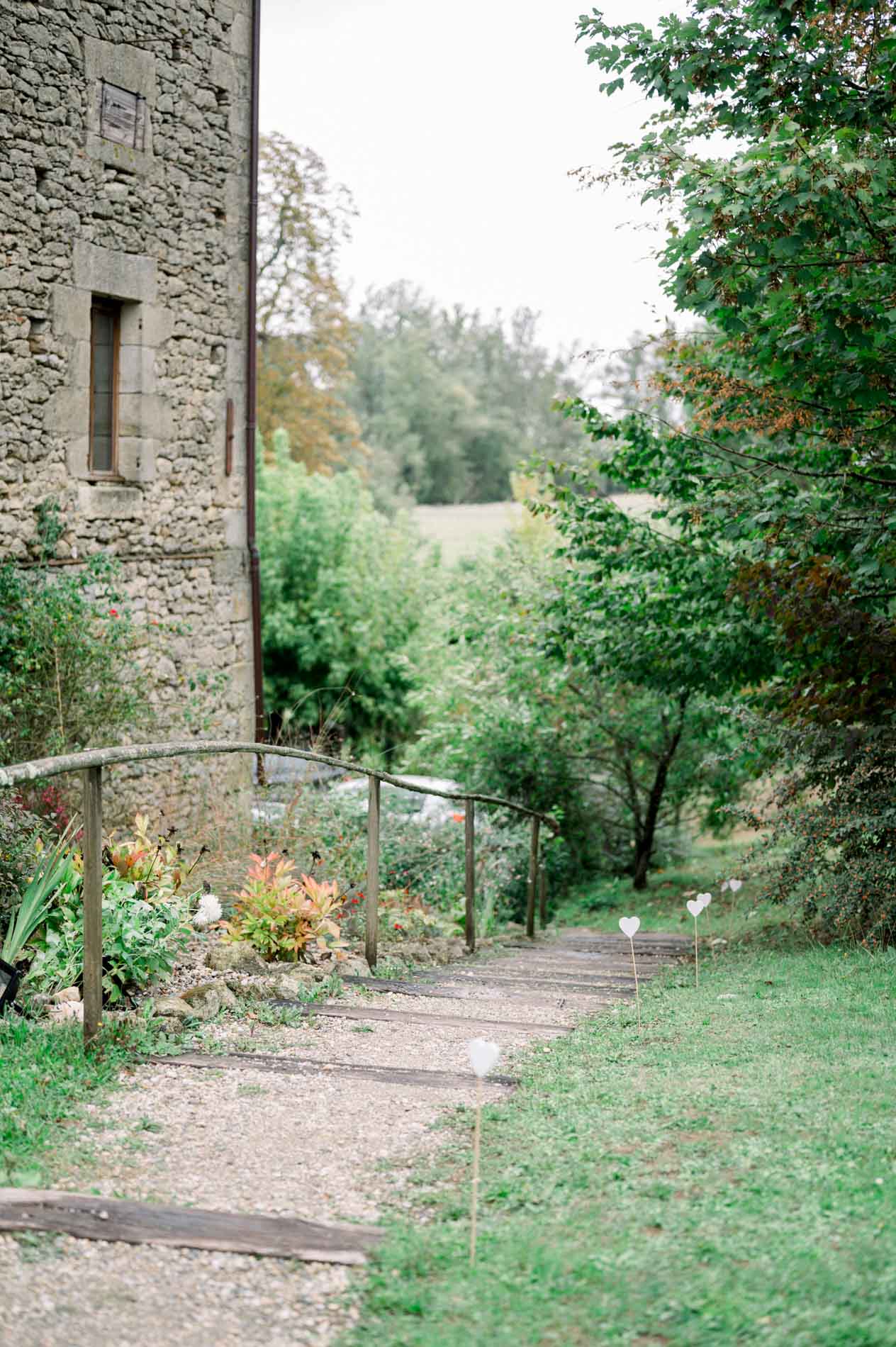 Green-edged path running alongside a stone tower on the farm