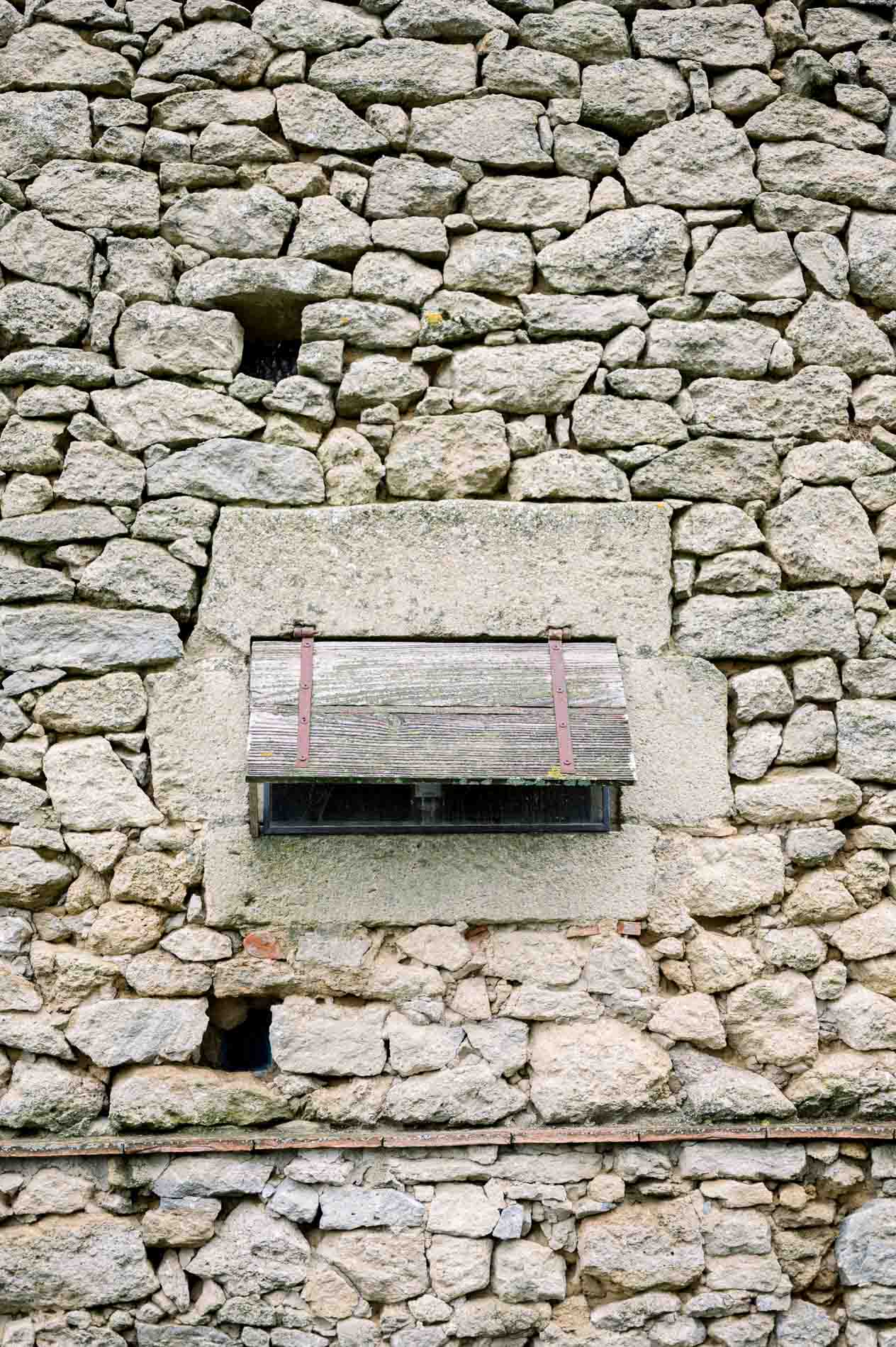 Dry-stone wall with an old wooden niche