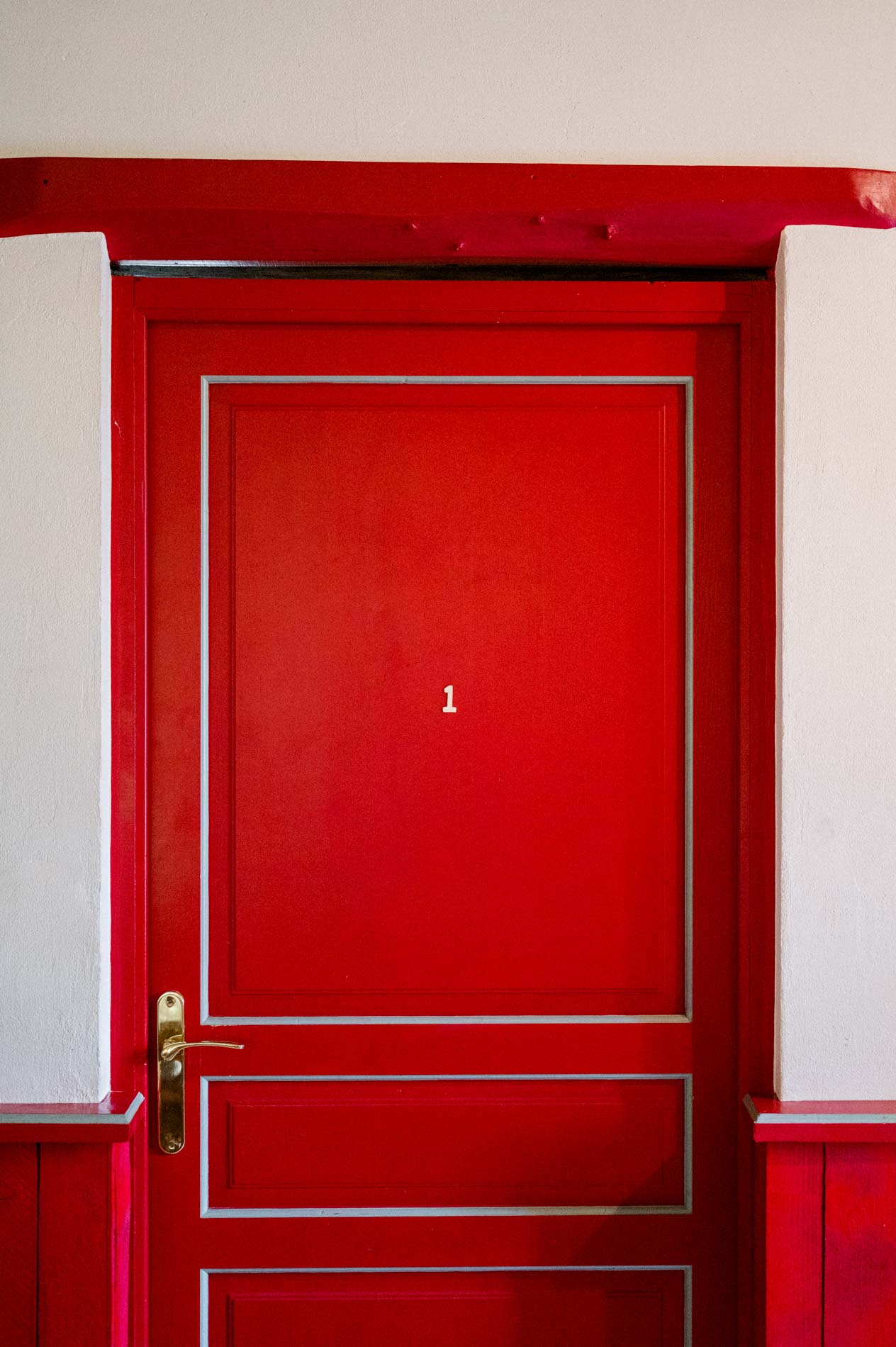 Numbered red bedroom door in the farm's guest house