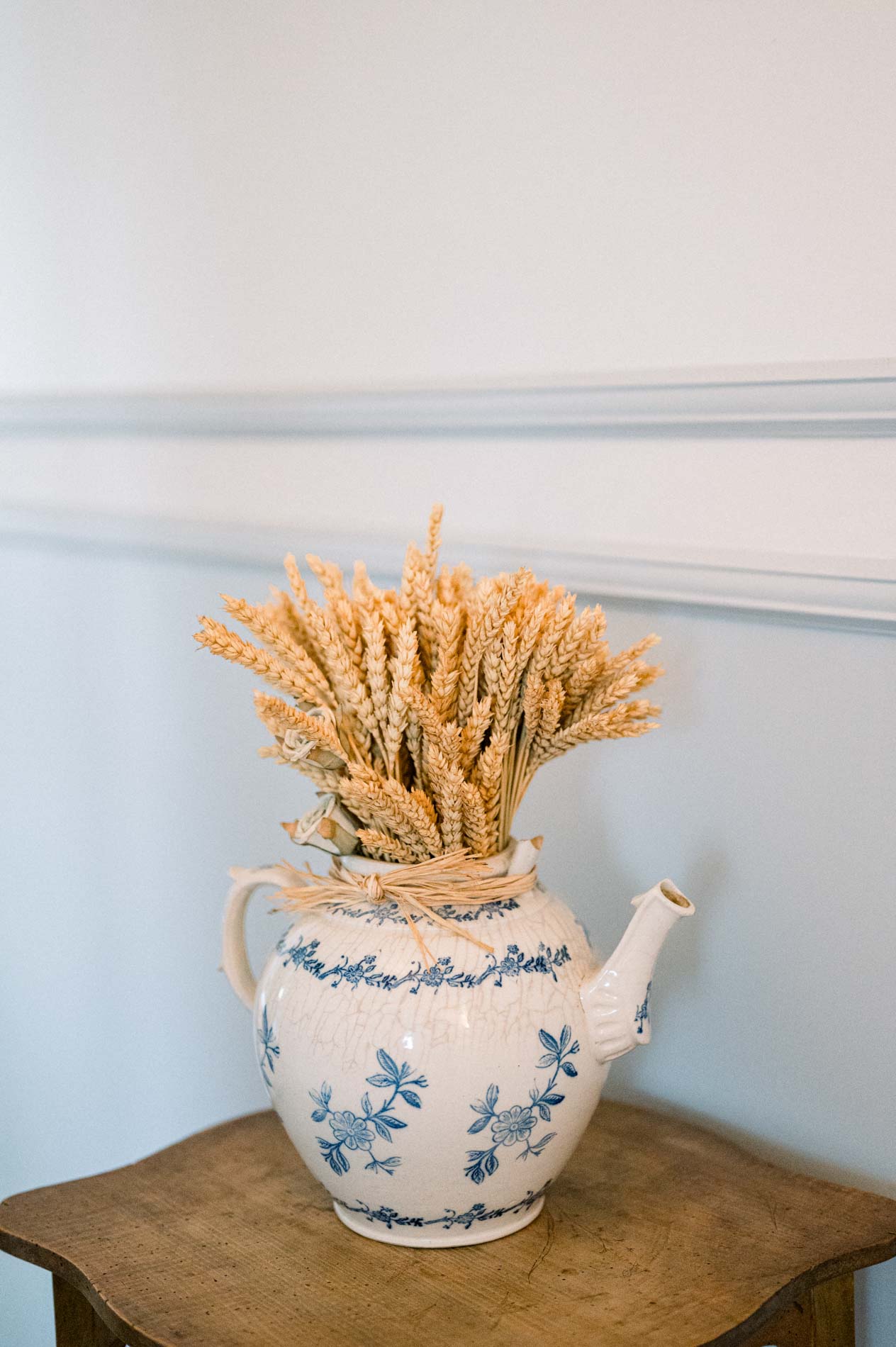 Bunch of wheat ears in a blue and white earthenware teapot