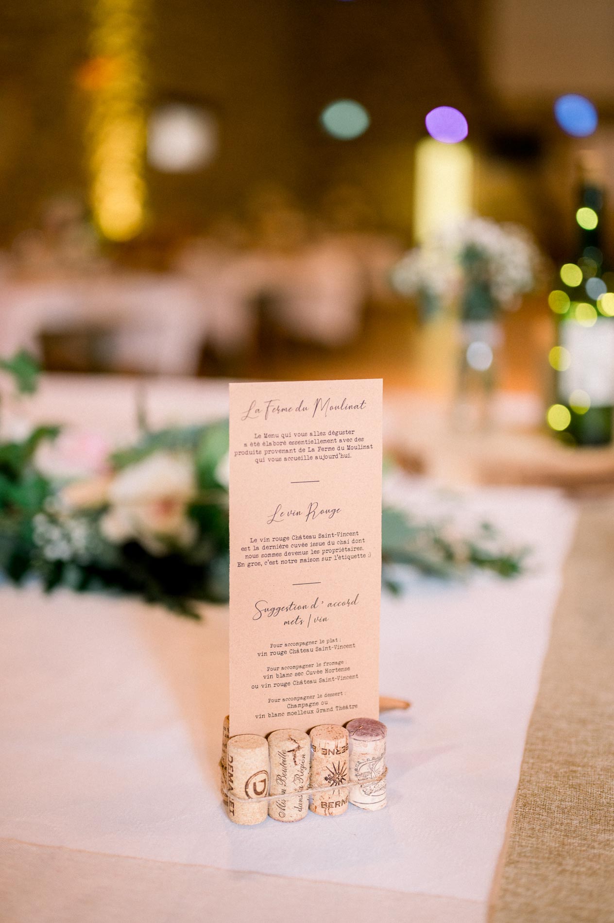 Wedding menu on a table glowing with string lights