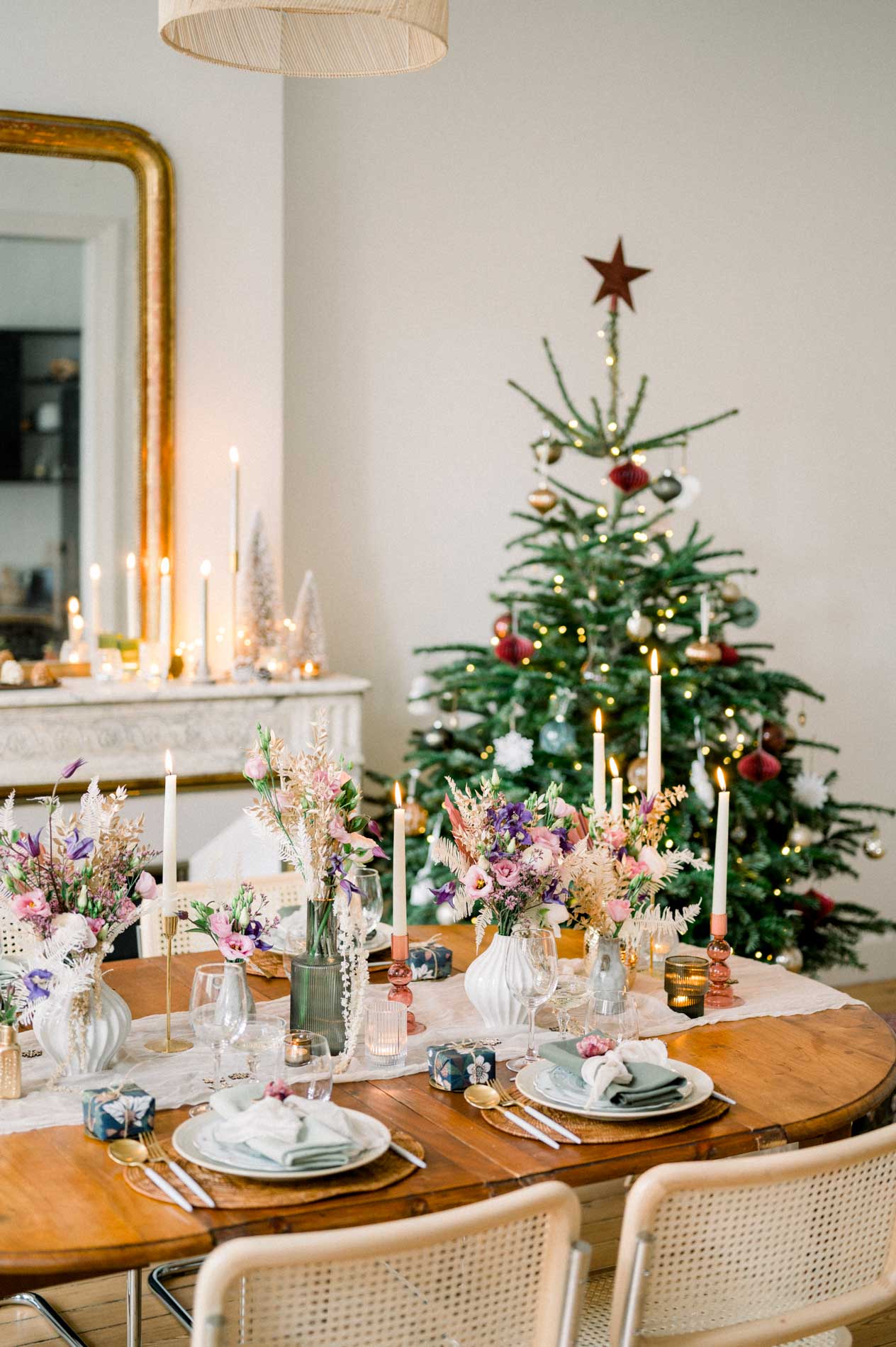Round Christmas table set beside the tree and fireplace