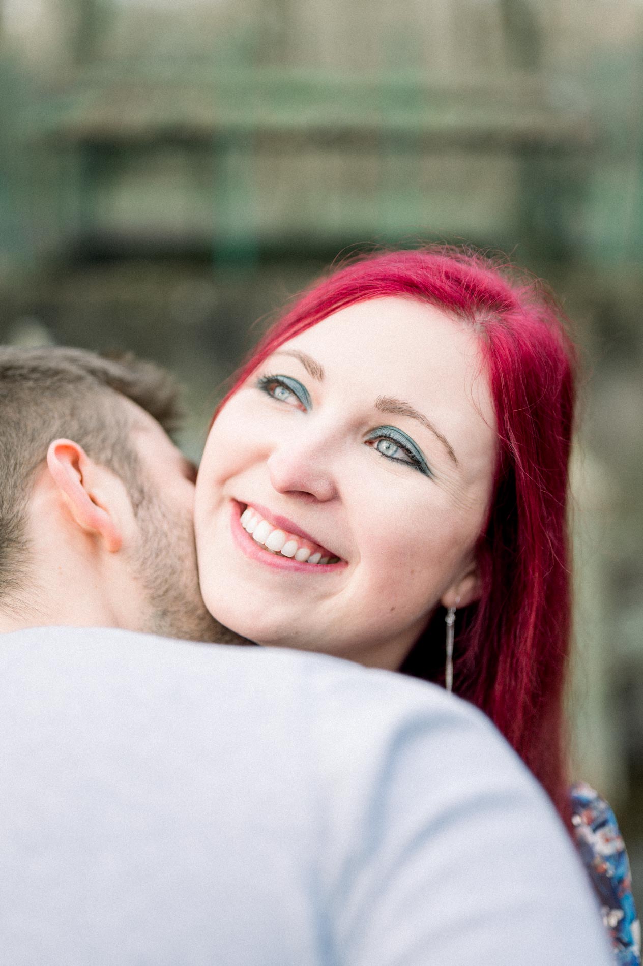 Smiling woman nestled against her partner's cheek