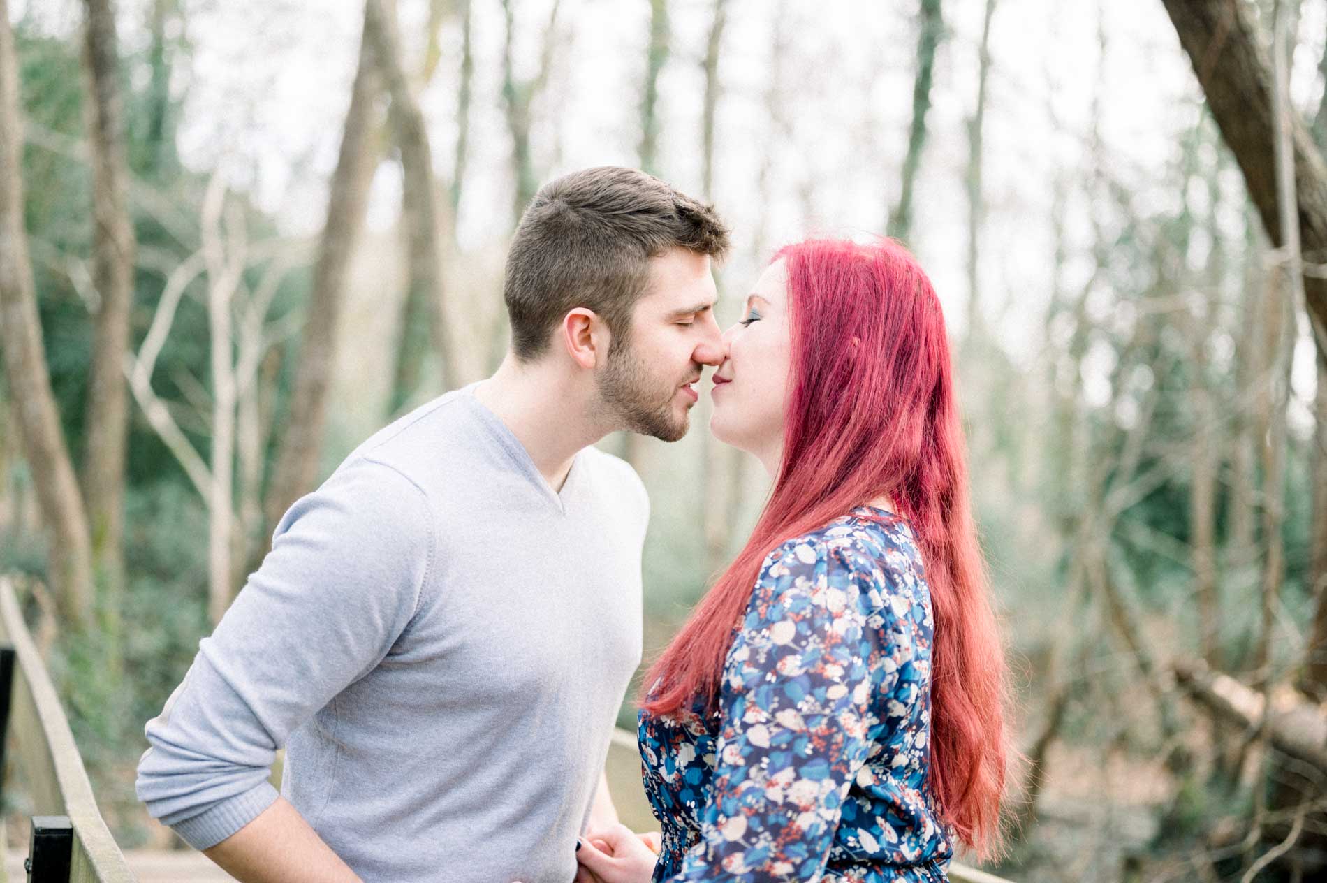Couple about to kiss among the trees