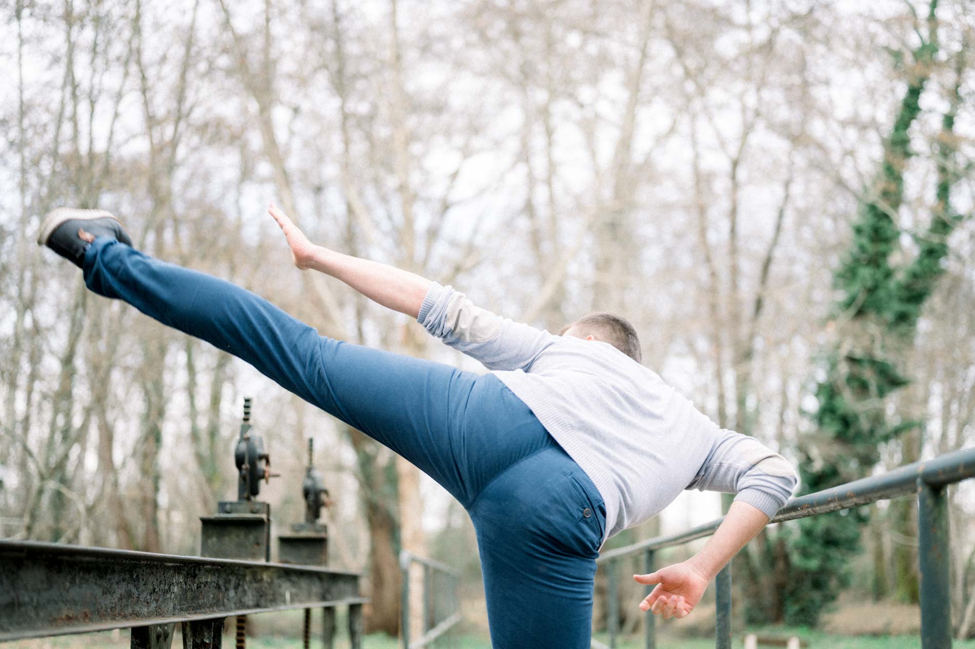 Man performing a high chanbara kick on the footbridge
