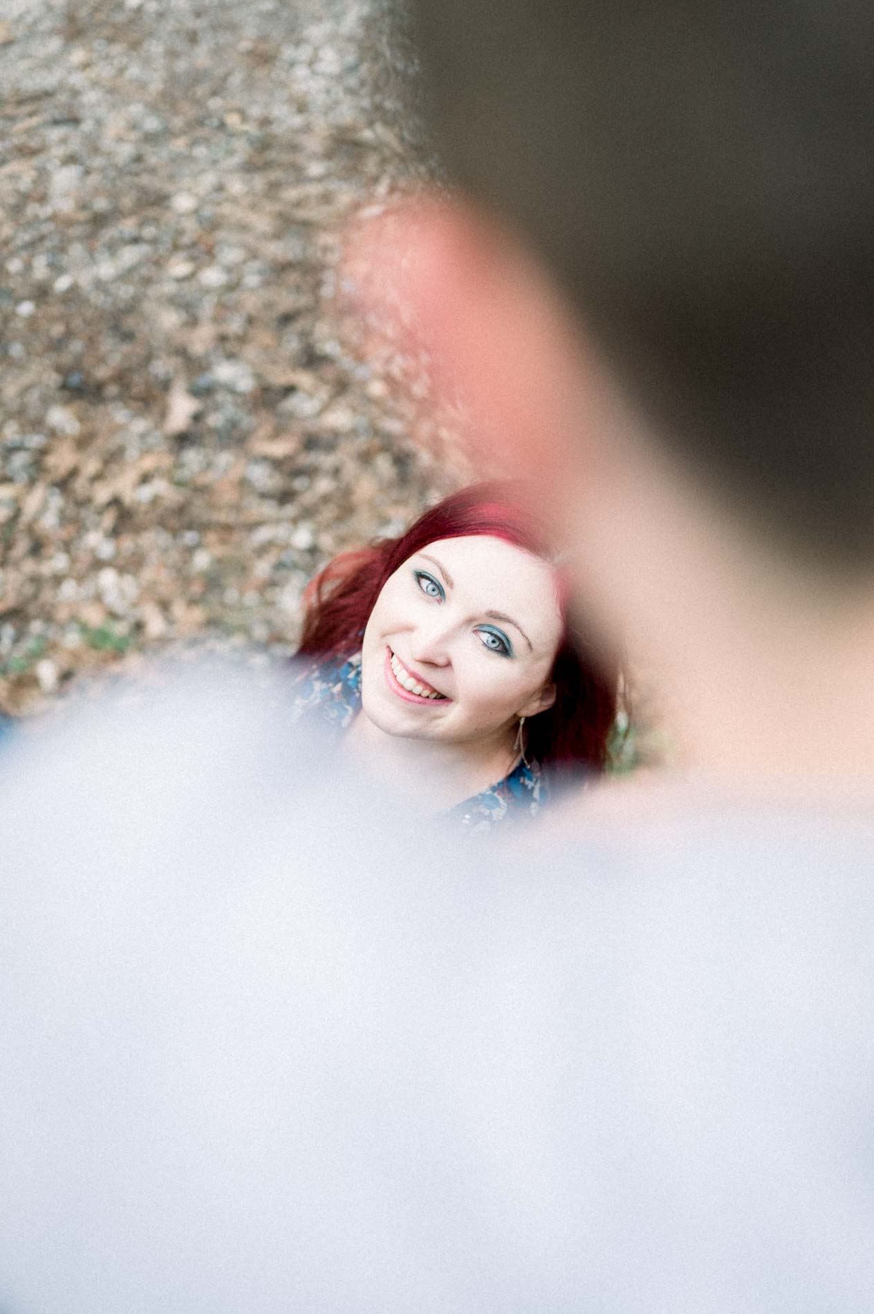 Smiling woman looking up at her partner, blurred in the foreground
