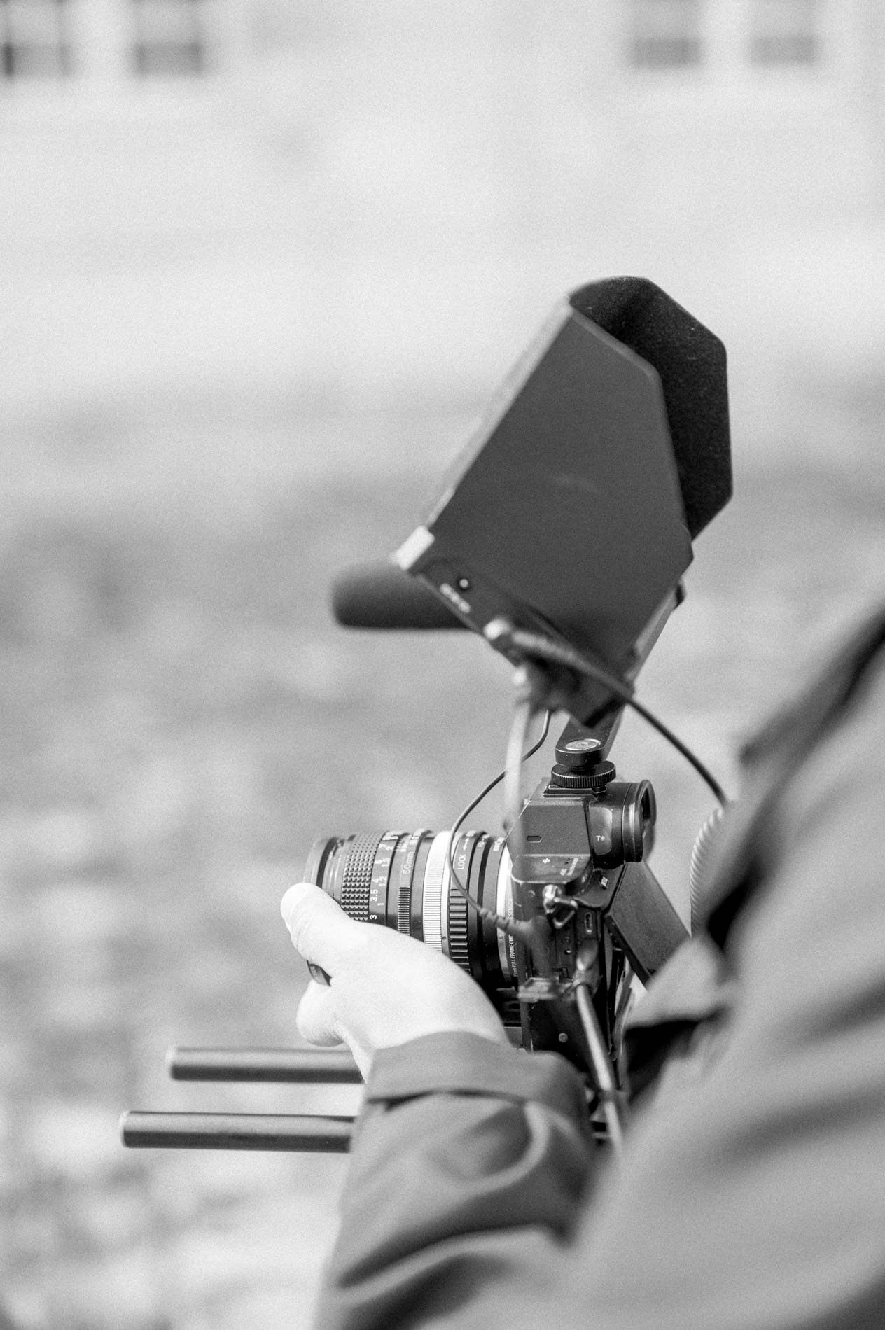 Videographer filming the civil wedding with his camera, in black and white