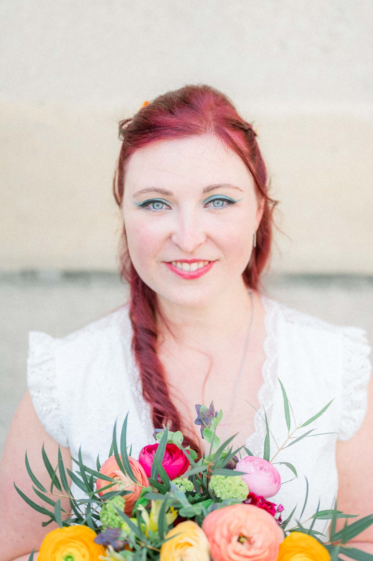 Close-up portrait of Tiffa, the blue-eyed bride with red hair